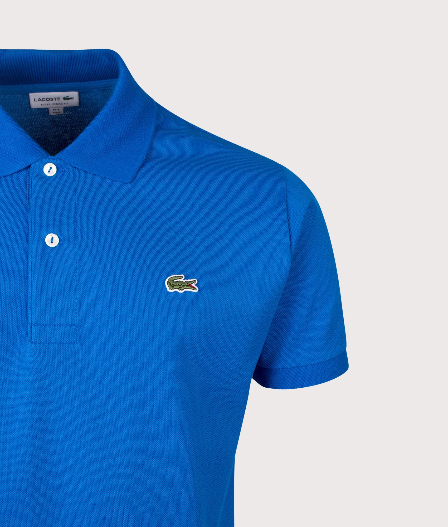 Lacoste Classic Fit L1212 Croc Logo Polo Shirt in Denim Blue at EQVVS Menswear. Detail shot.
