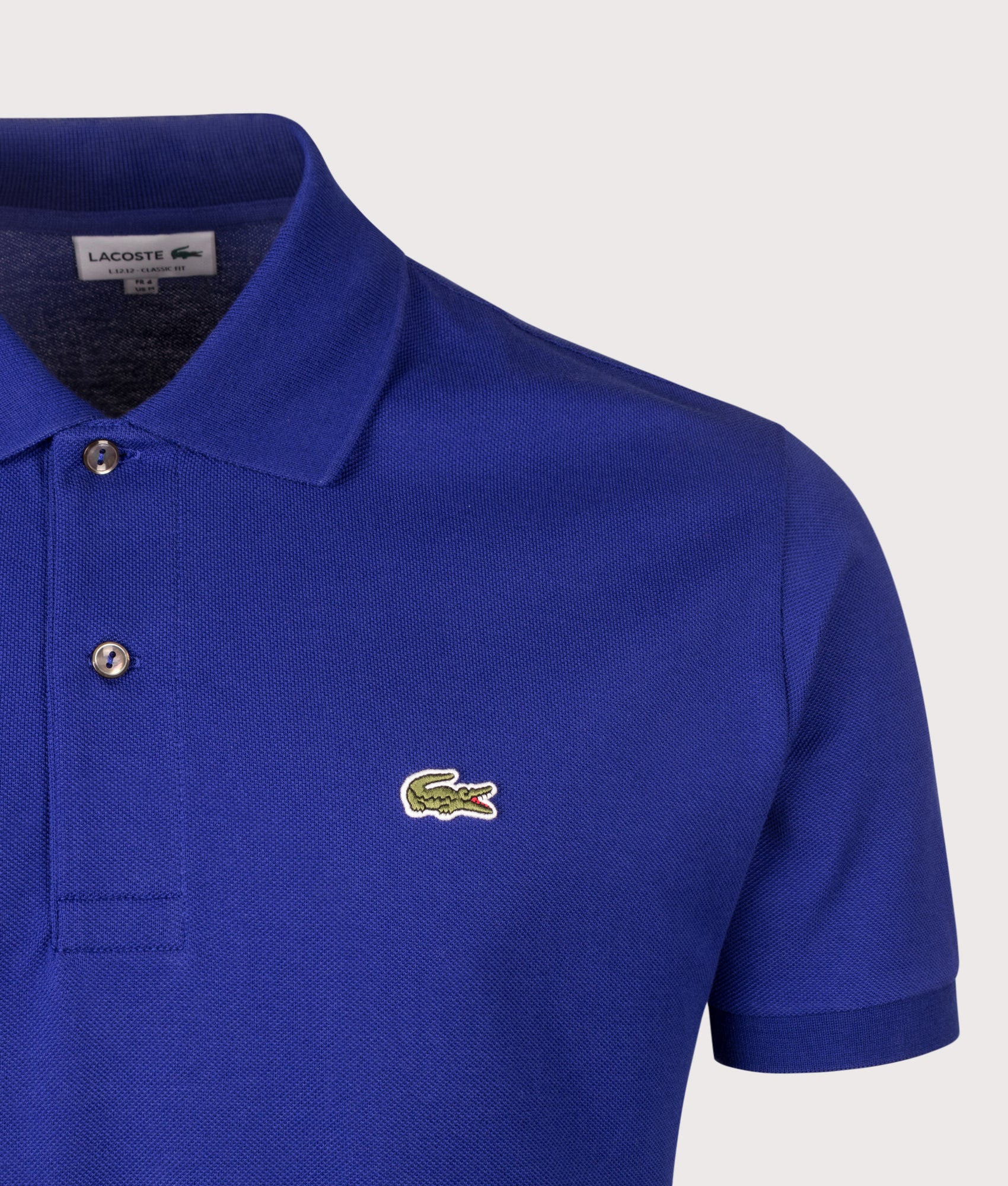 Lacoste Classic Fit L1212 Croc Logo Polo Shirt in Indigo Blue at EQVVS Menswear. Detail shot.