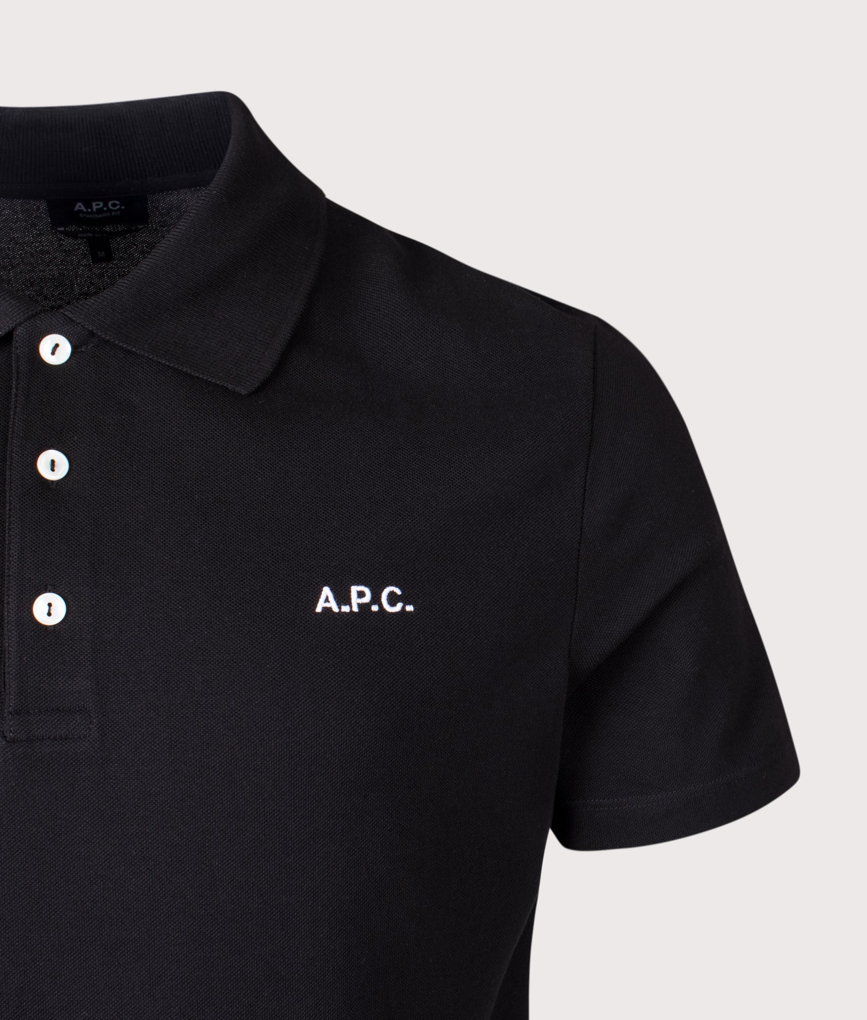 A.P.C. Relaxed Fit Standard Polo Shirt in Black at EQVVS Menswear. Detail shot.