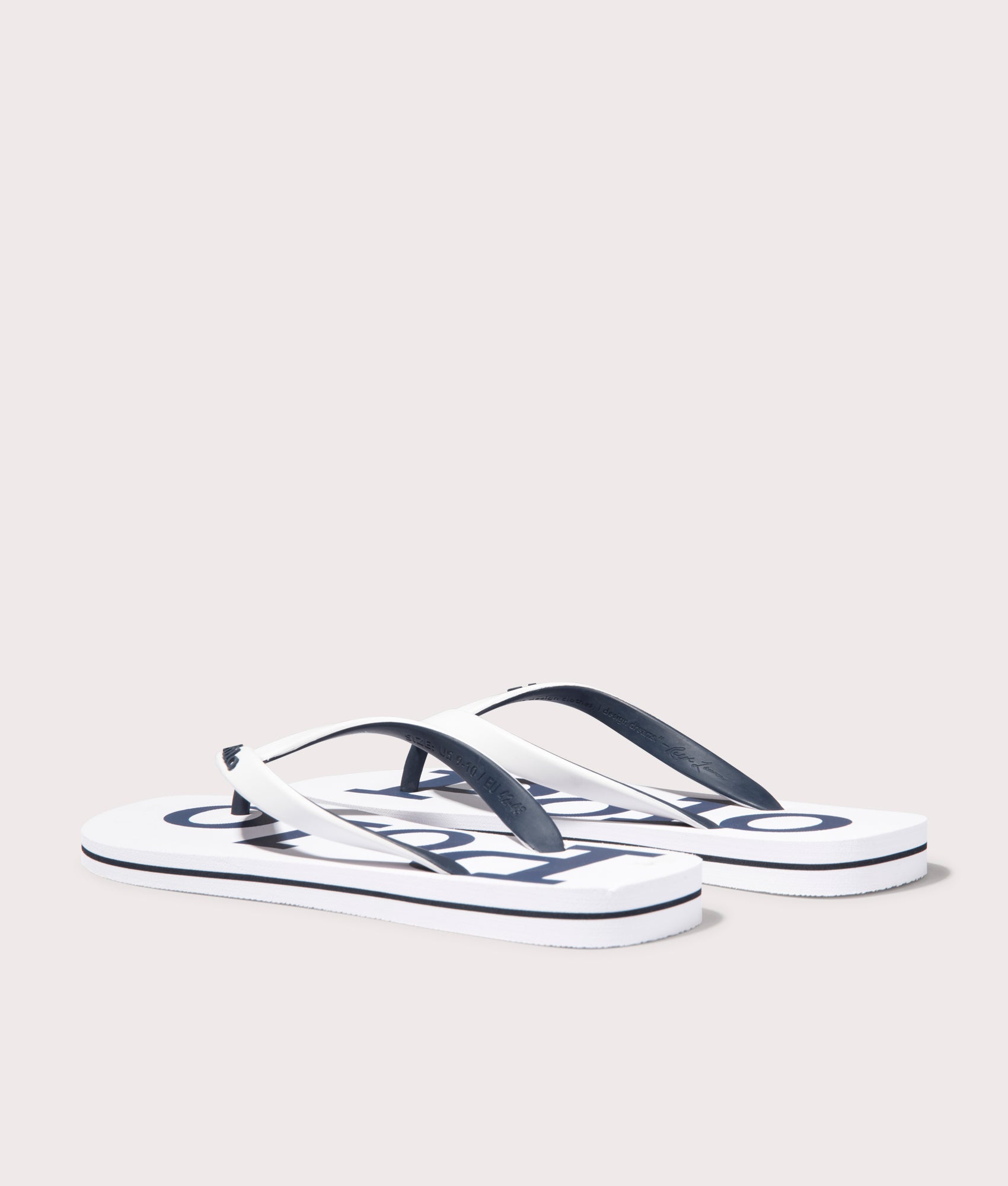Polo Ralph Lauren Bolt Logo Flip Flops in White/Newport Navy. Shot at EQVVS. Back shot 