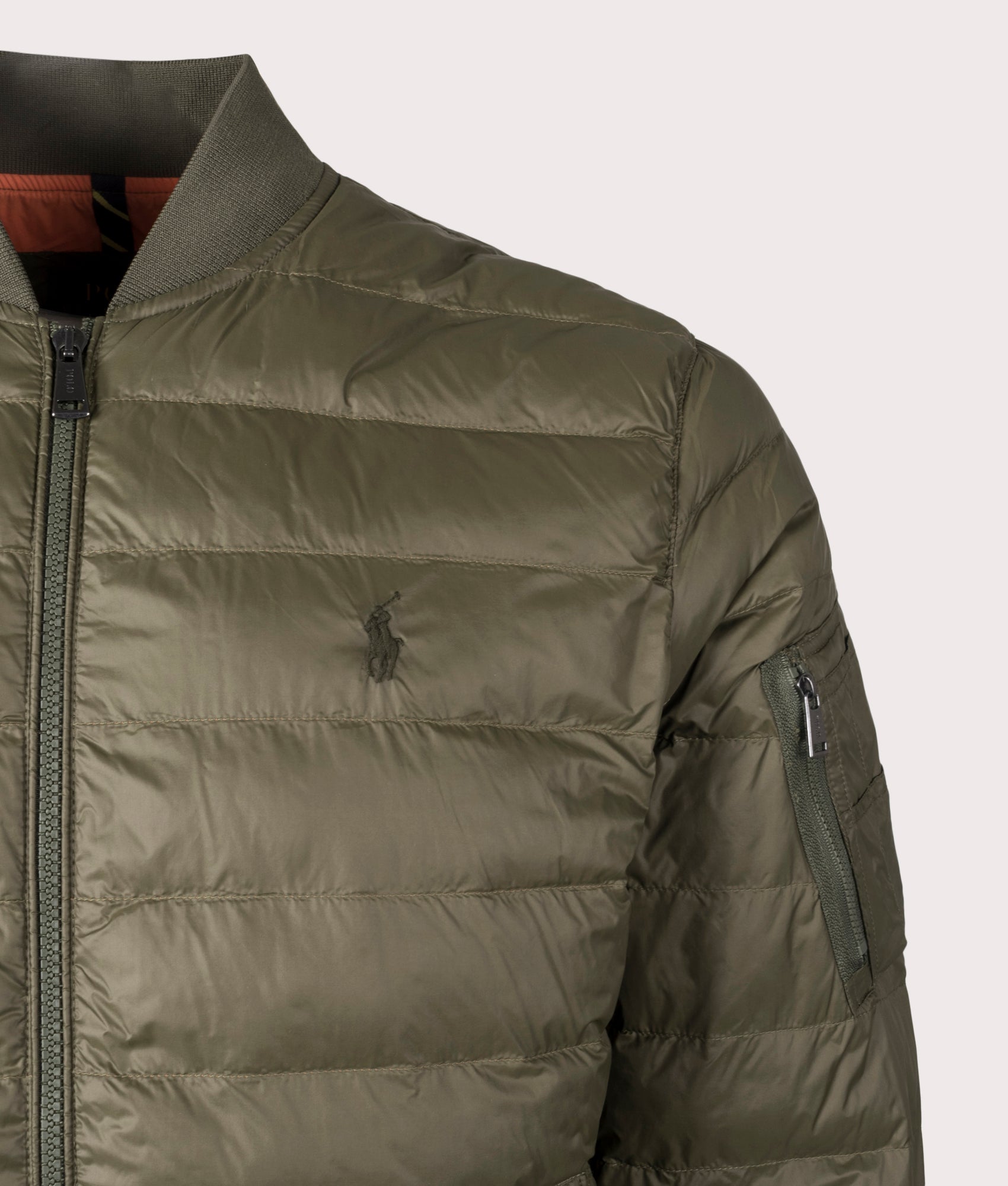 The Colden Packable Bomber Jacket in Canopy Olive from Polo Ralph Lauren. Detail angle shot at EQVVS.