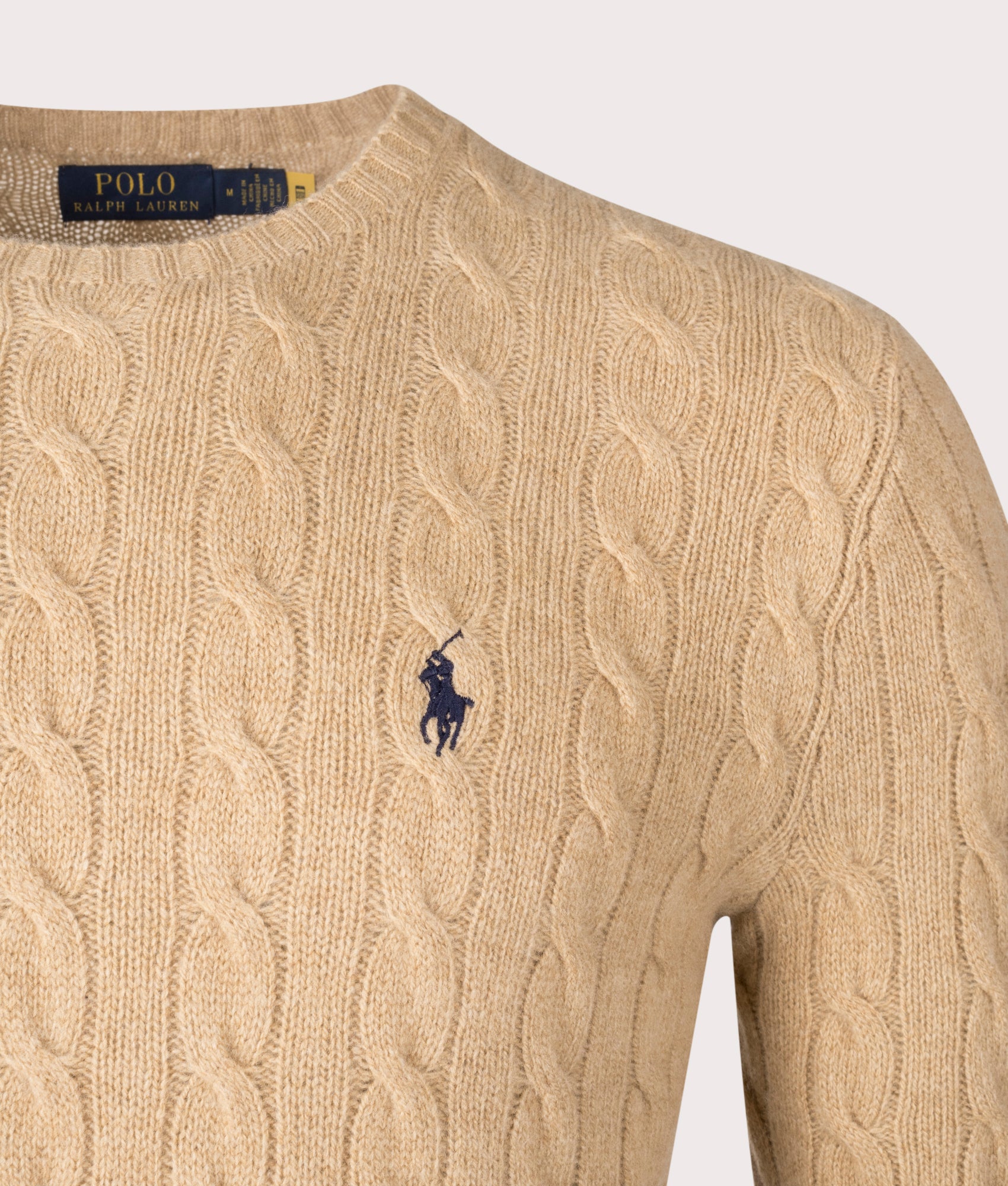 Polo Ralph Lauren Cashmere Blend Cable Knit Jumper in Camel Melange, 90% Wool, 10% Cashmere at EQVVS. Detailed Logo Shot. 