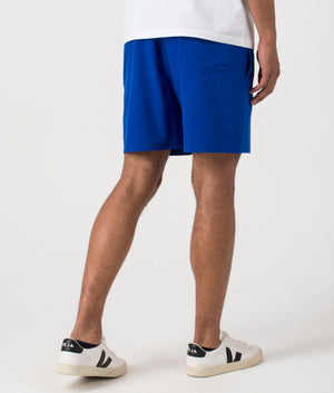 Regular Fit Traveler Mid Swim Shorts in Rugby Royal. Back angle shot at EQVVS.