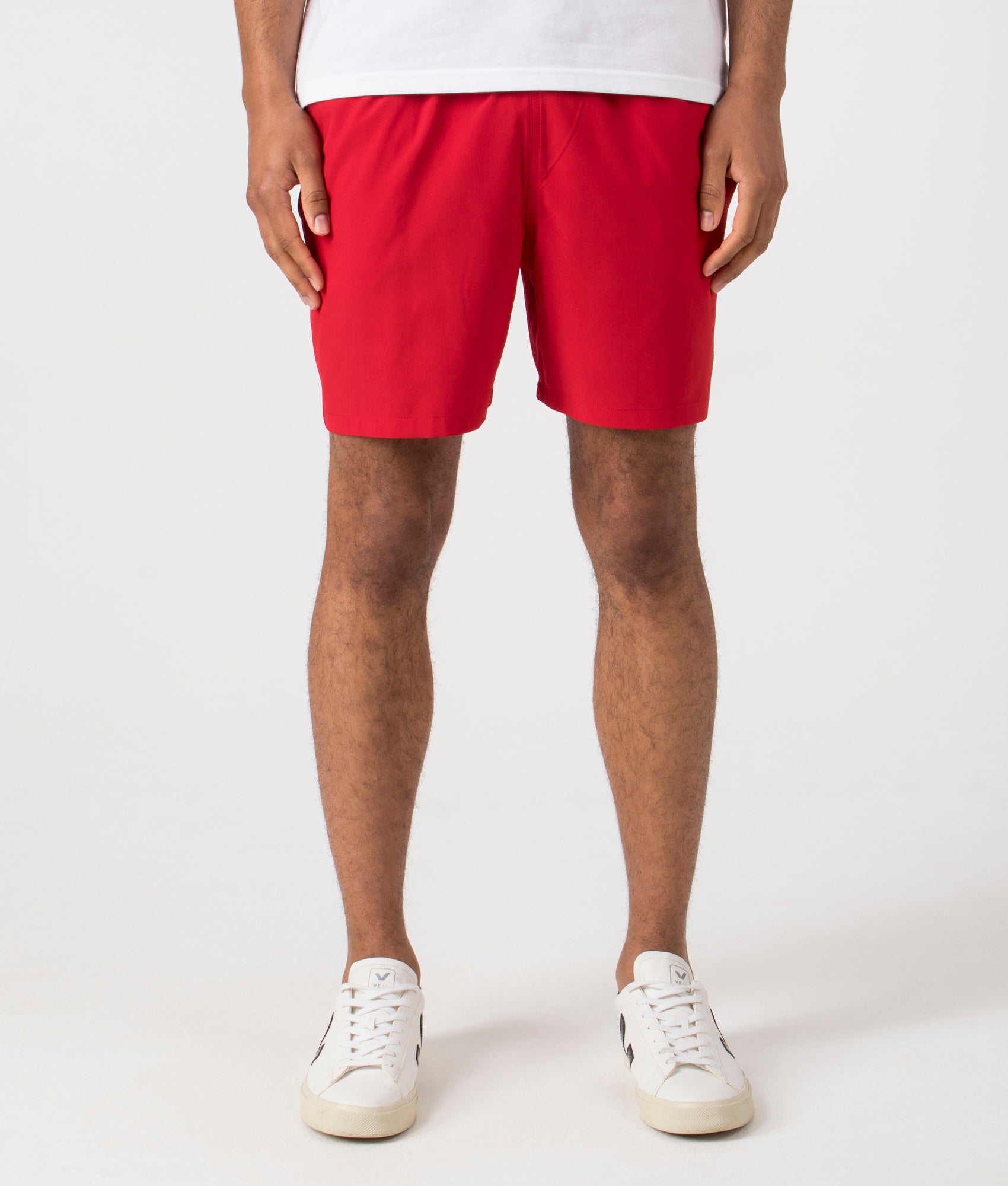 Regular Fit Traveler Mid Swim Shorts in Red. Front angle shot at EQVVS.