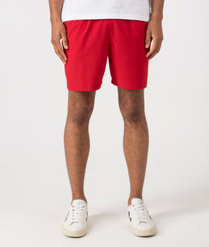Regular Fit Traveler Mid Swim Shorts in Red. Front angle shot at EQVVS.