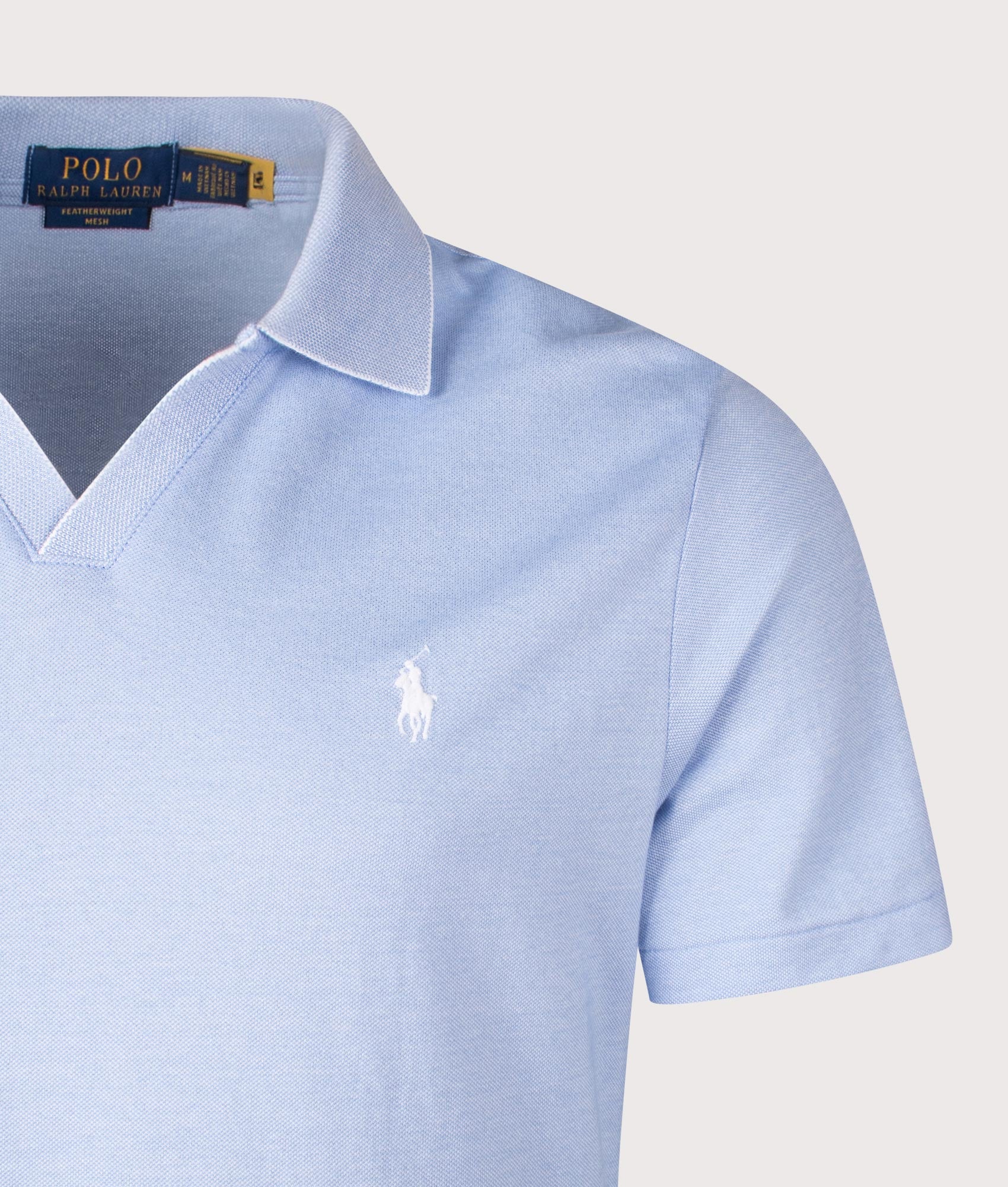 Classic Fit Featherweight Polo Shirt. Shot by EQVVS. Front detail shot.
