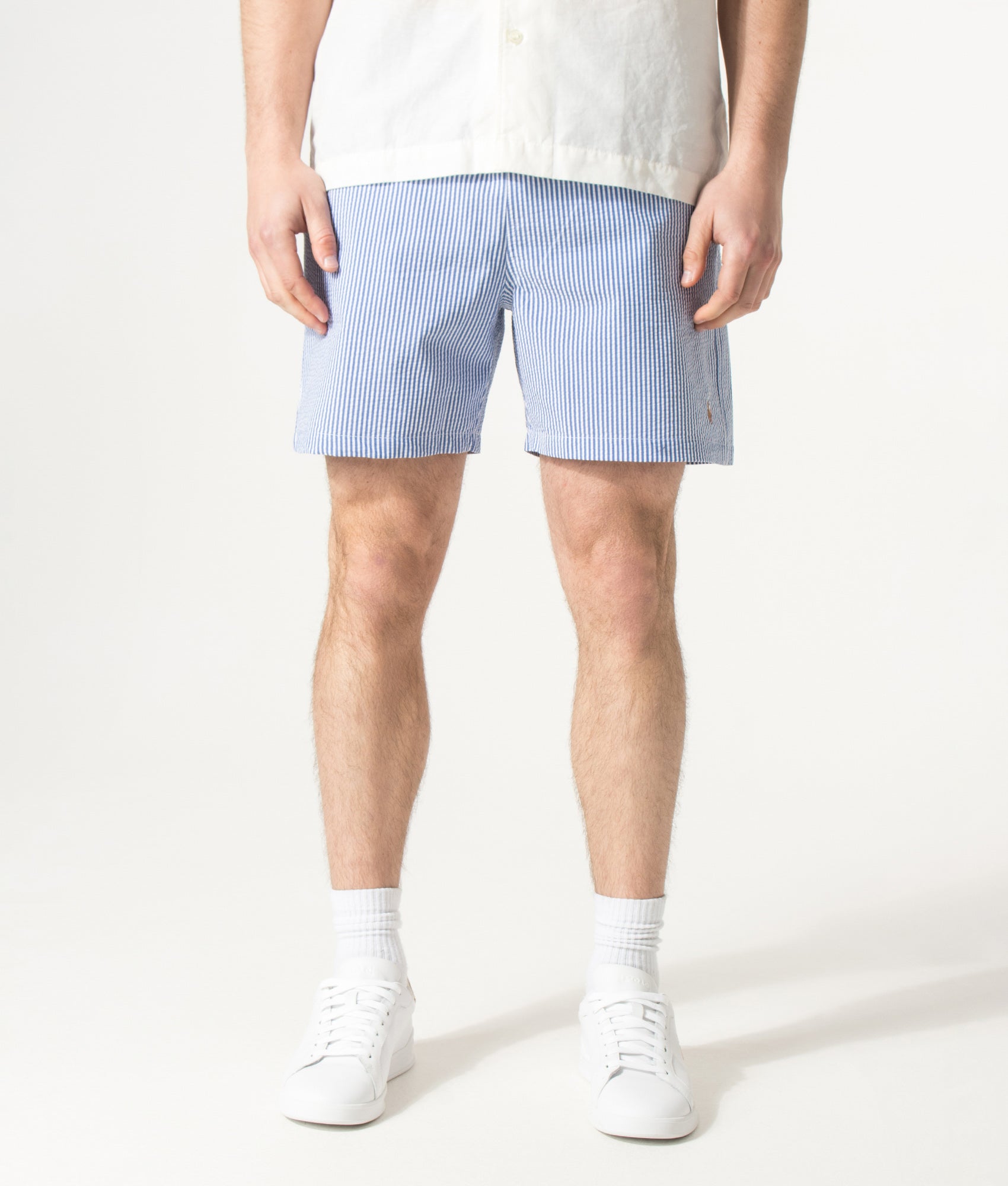 Polo Ralph Lauren 5.75 Inch Traveler Classic Swim Trunks in Cruise Royal Seersucker at EQVVS Menswear. Model front shot.