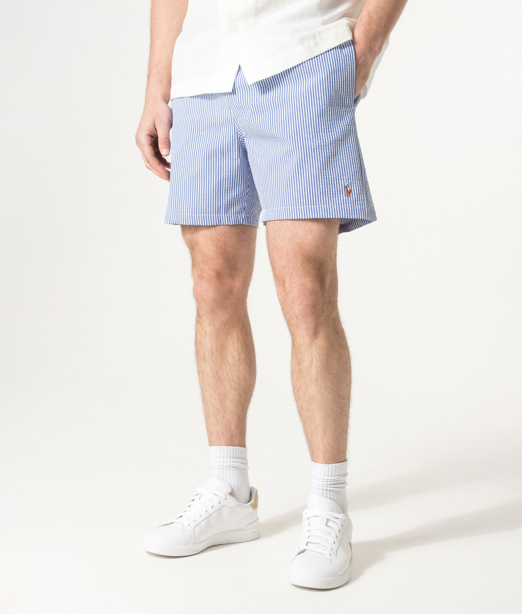 Polo Ralph Lauren 5.75 Inch Traveler Classic Swim Trunks in Cruise Royal Seersucker at EQVVS Menswear. Angled model front shot.