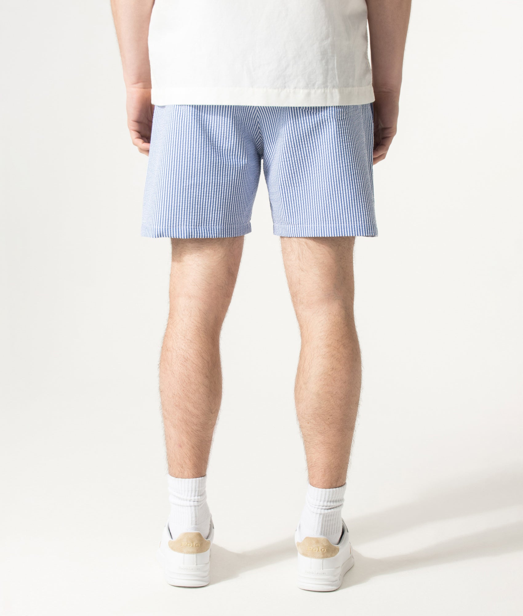 Polo Ralph Lauren 5.75 Inch Traveler Classic Swim Trunks in Cruise Royal Seersucker at EQVVS Menswear. Model back shot.
