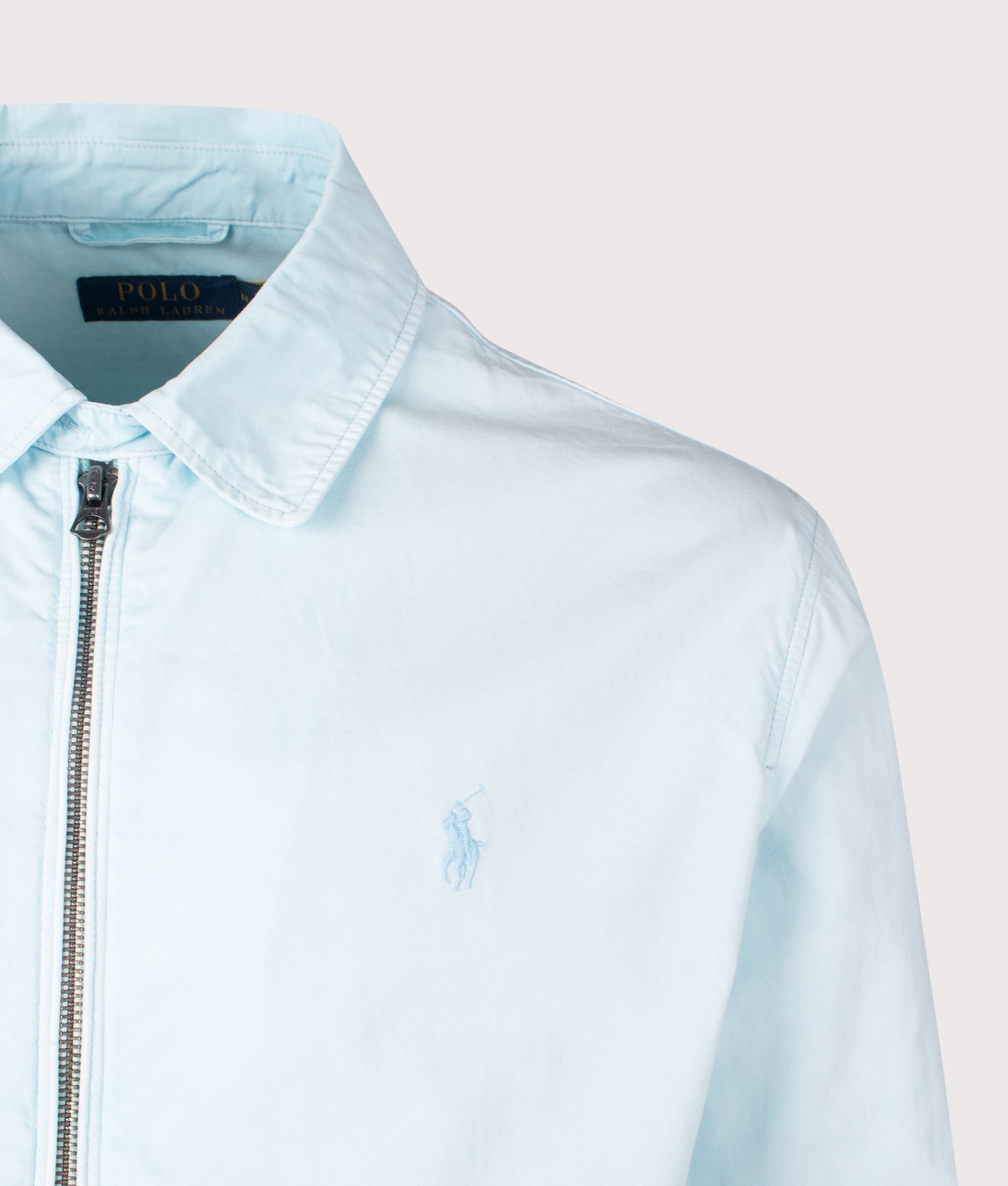 Polo Ralph Lauren The Bayport Mineral-Dyed Poplin Jacket in Sky. Shot at EQVVS. Front detail shot 