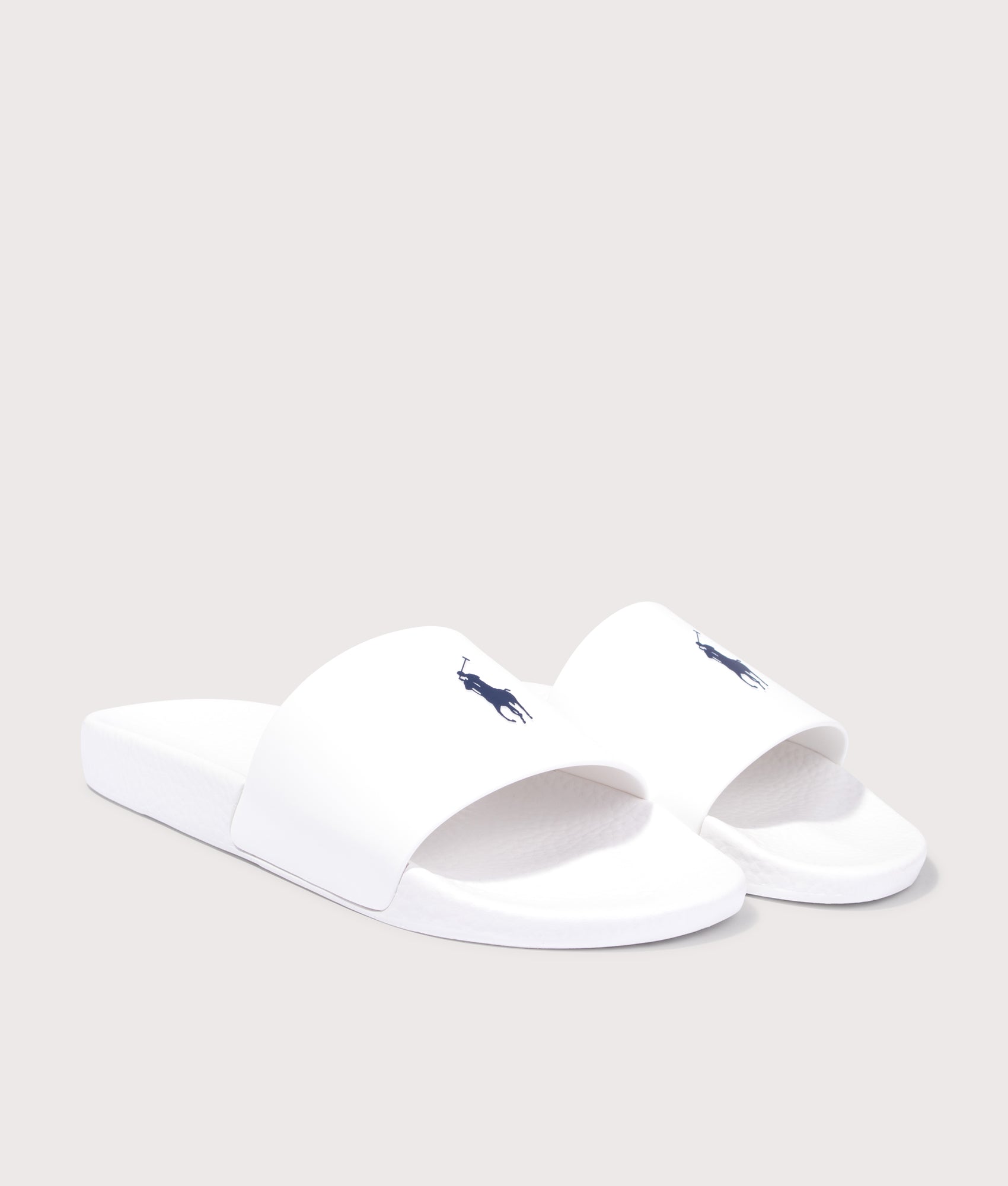 Polo Ralph Lauren Signature Pony Sliders in Ceramic White at EQVVS Menswear. Angled front shot.