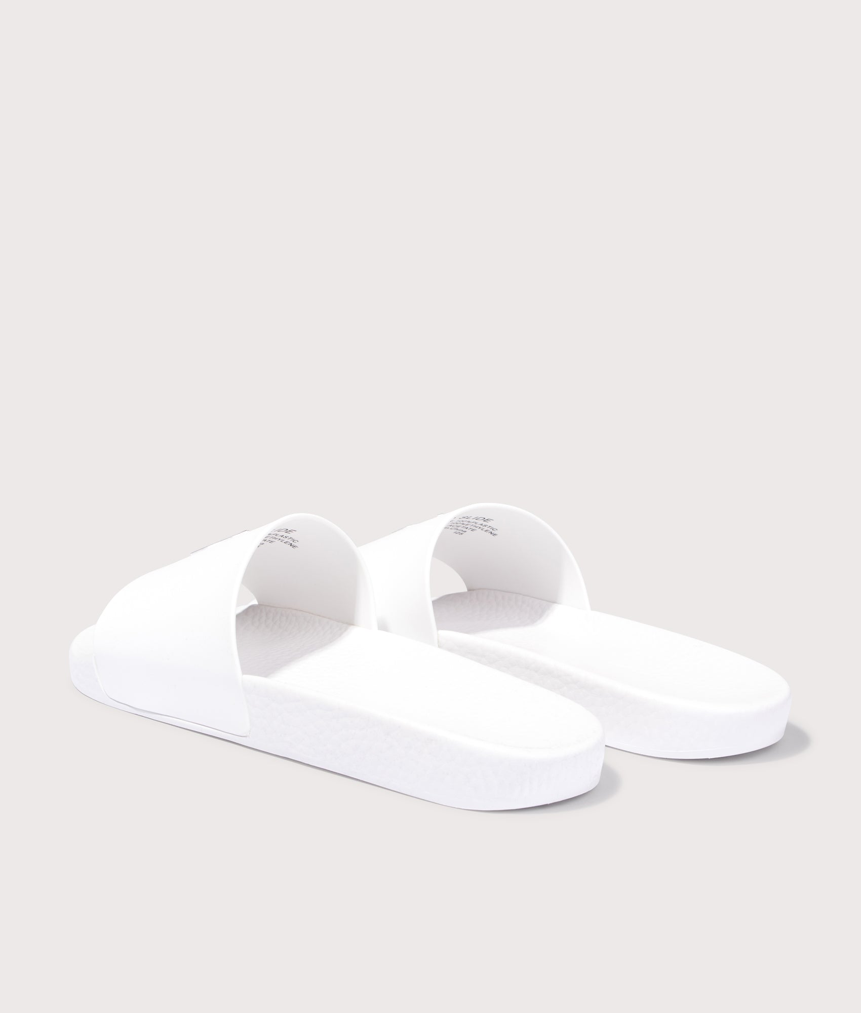 Polo Ralph Lauren Signature Pony Sliders in Ceramic White at EQVVS Menswear. Angled back shot.