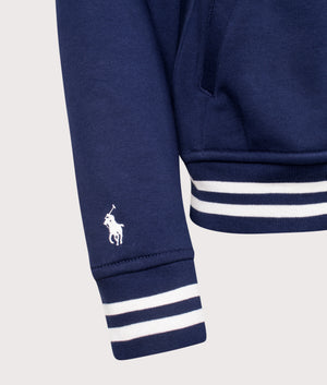 Logo Baseball Jacket by Polo Ralph Lauren in Newport Navy. Shot by EQVVS. Detail sleeve shot.