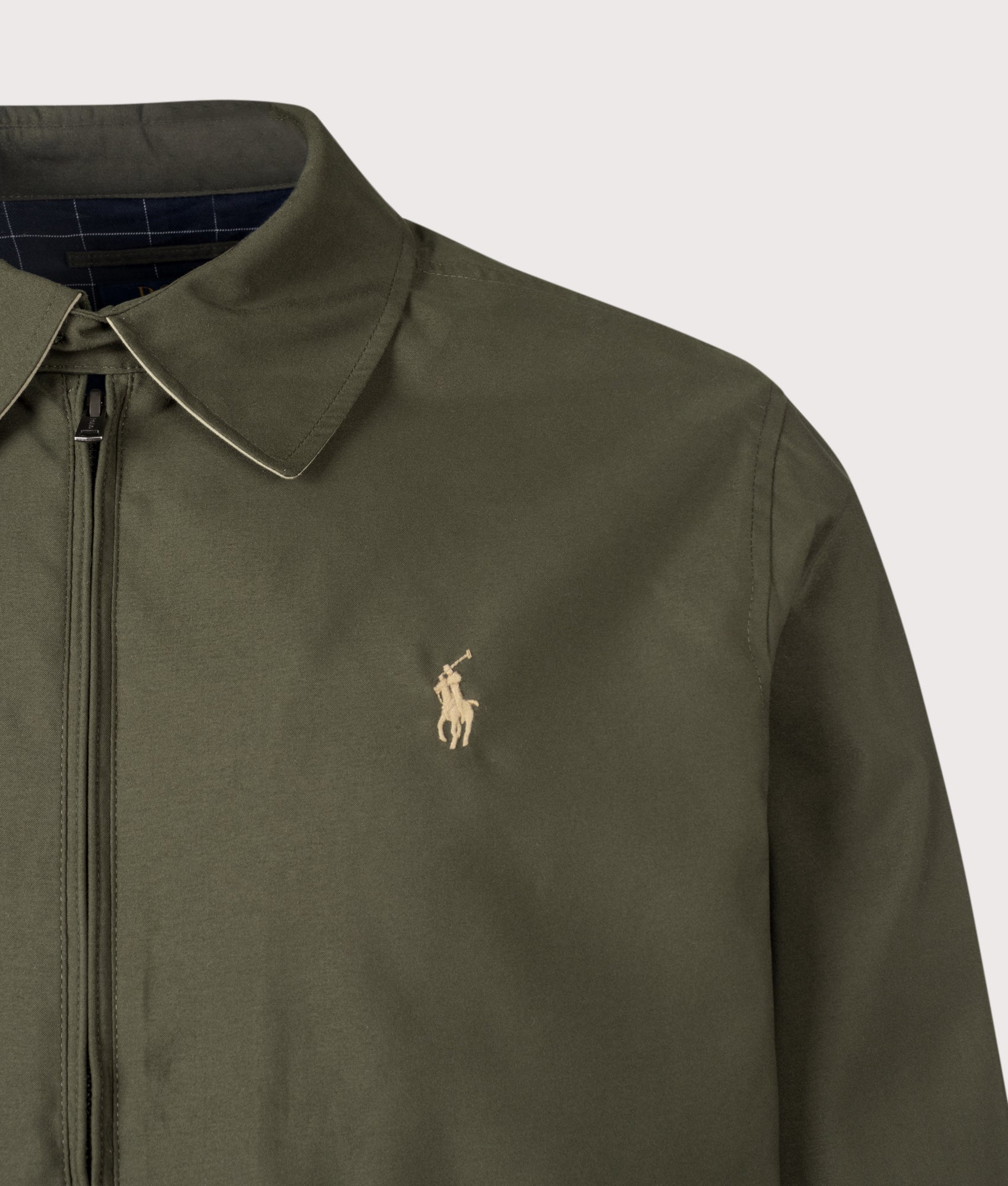 Twill Bi-Swing Lined Windbreaker in Company Olive by Polo Ralph Lauren. Shot by EQVVS. Detail logo shot.