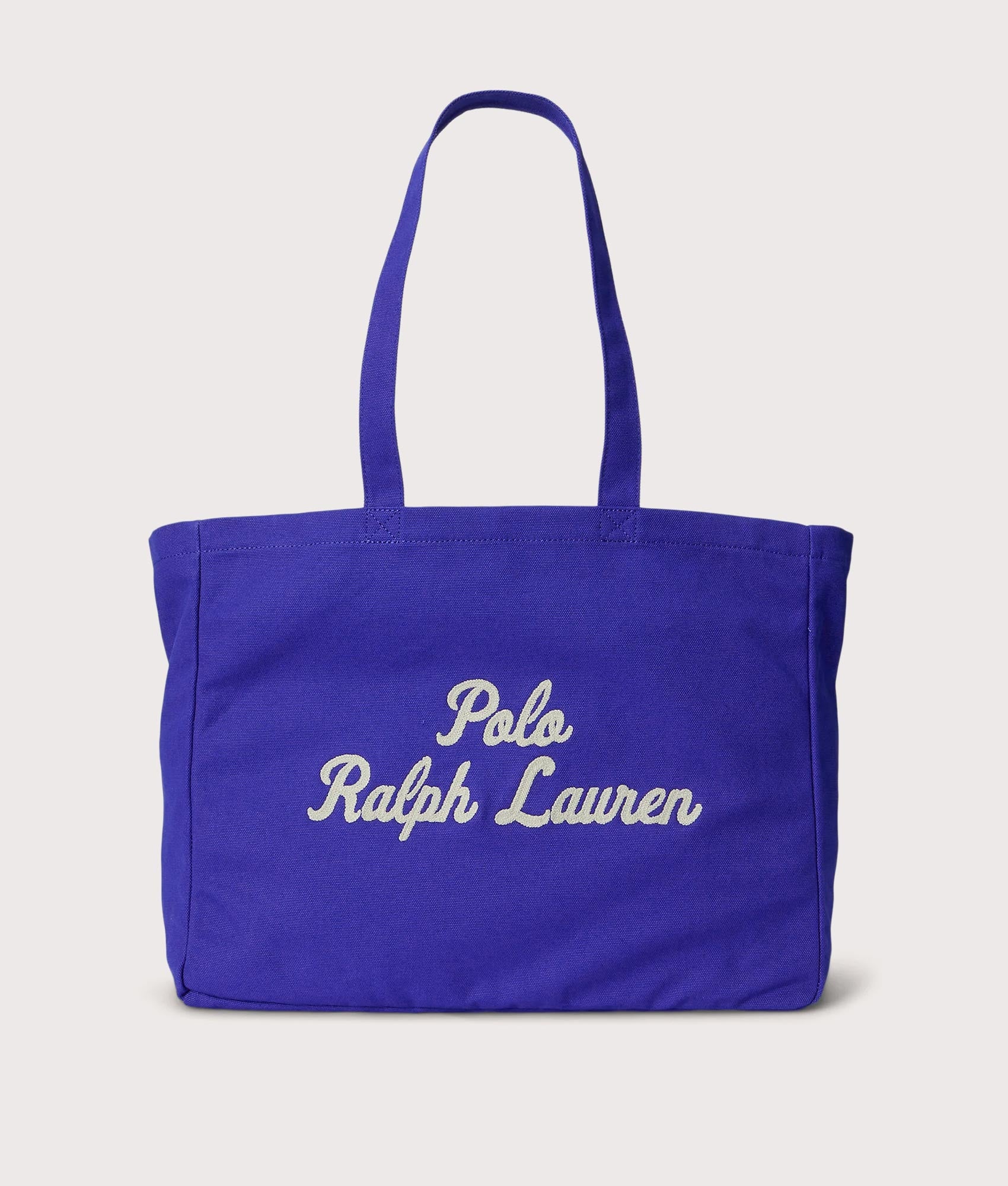 Polo Ralph Lauren Embroidered Canvas Tote Bag in Sapphire Star at EQVVS Menswear. Front shot.