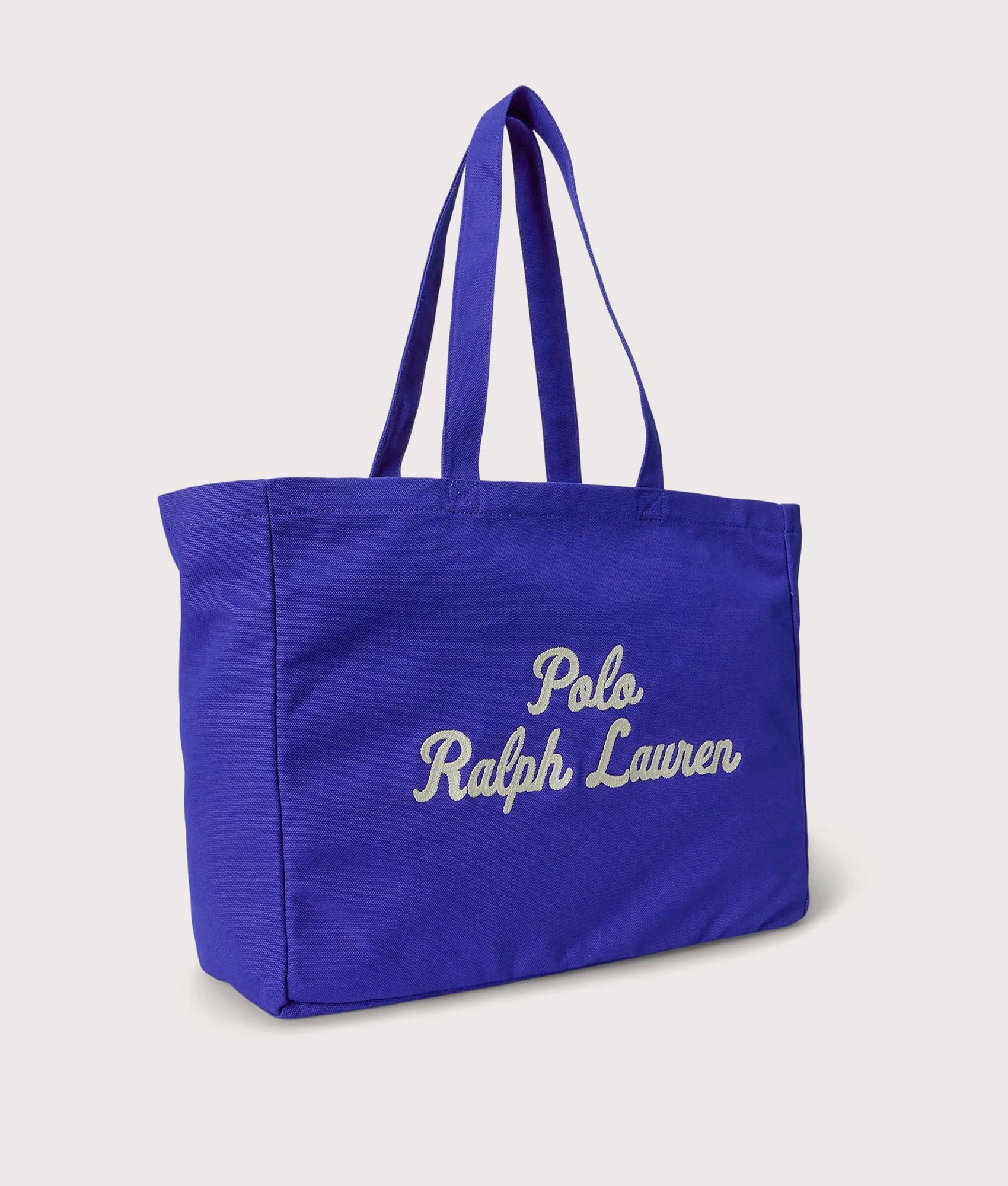 Polo Ralph Lauren Embroidered Canvas Tote Bag in Sapphire Star at EQVVS Menswear. Angled front shot.