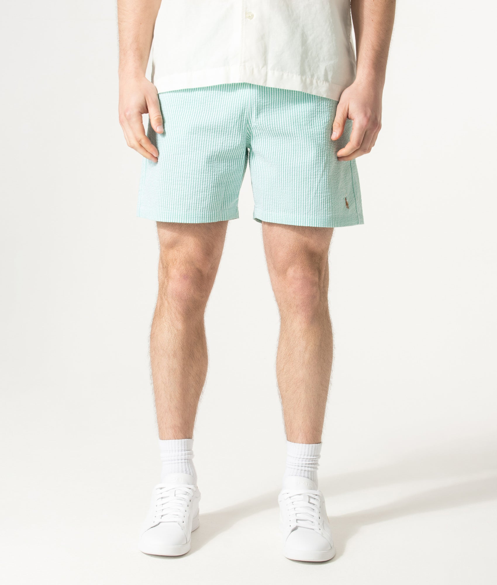 Polo Ralph Lauren 5.75 Inch Traveler Classic Swim Trunks in Key West Green Stripe at EQVVS Menswear. Model front shot.