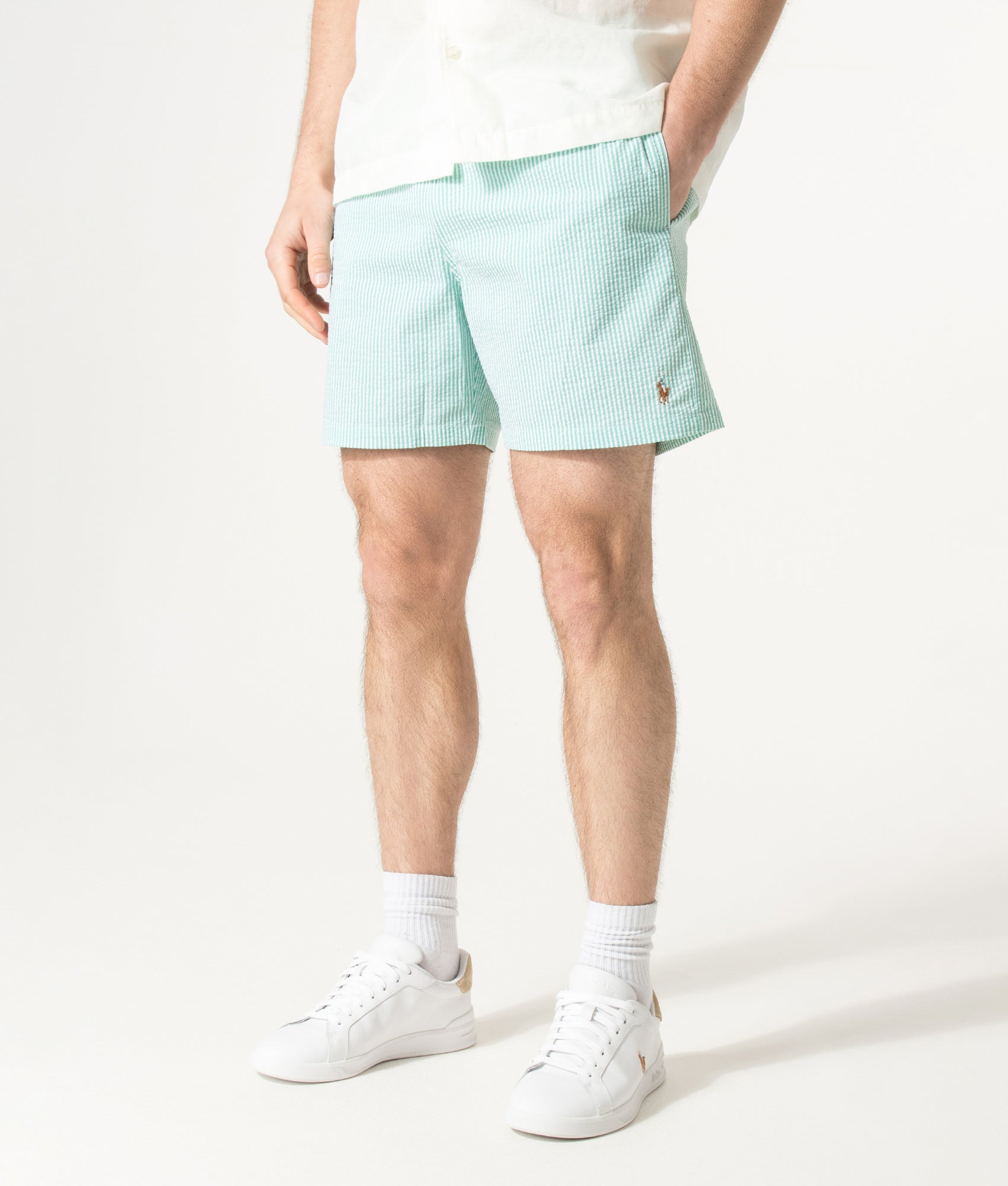 Polo Ralph Lauren 5.75 Inch Traveler Classic Swim Trunks in Key West Green Stripe at EQVVS Menswear. Angled model front shot.
