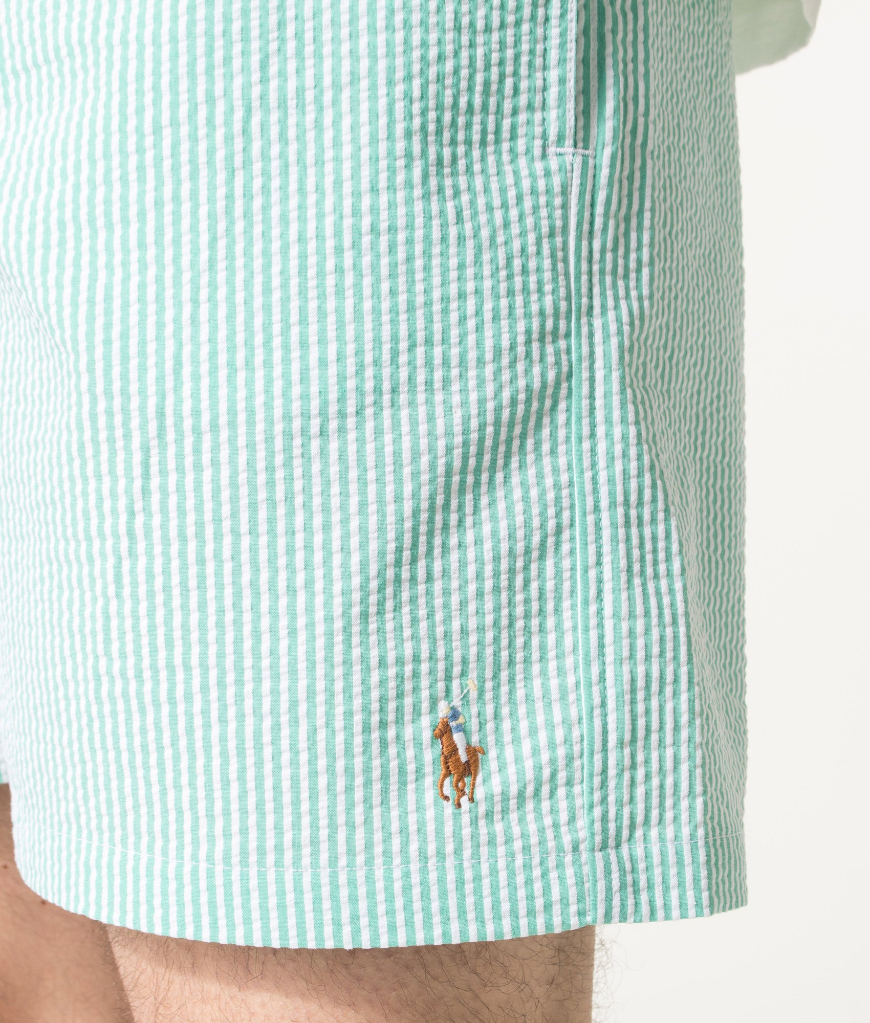 Polo Ralph Lauren 5.75 Inch Traveler Classic Swim Trunks in Key West Green Stripe at EQVVS Menswear. Detail shot.