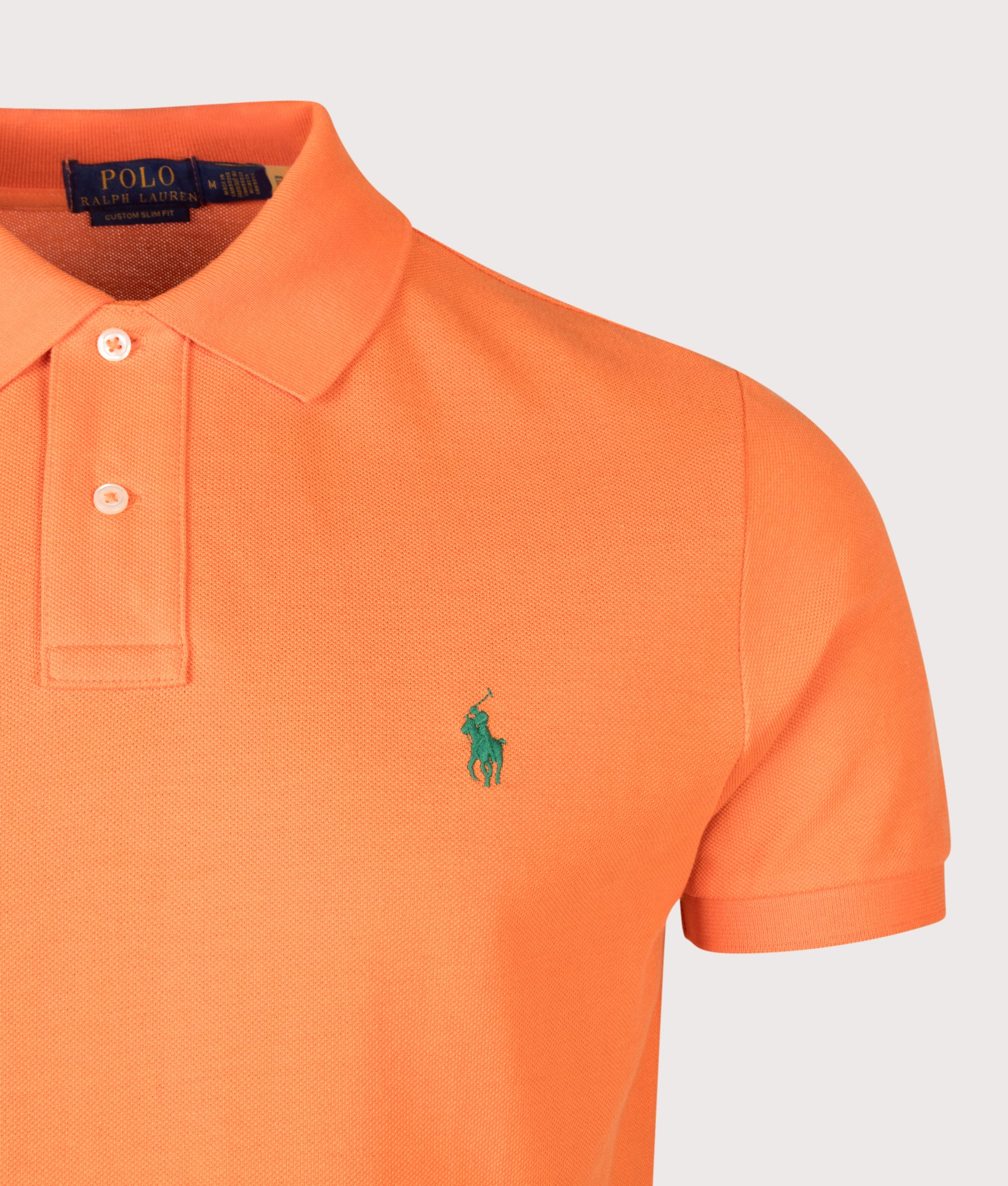 Custom Slim Fit Mesh Polo Shirt in Kona Orange by Polo Ralph Lauren. Shot by EQVVS. Detail shot.