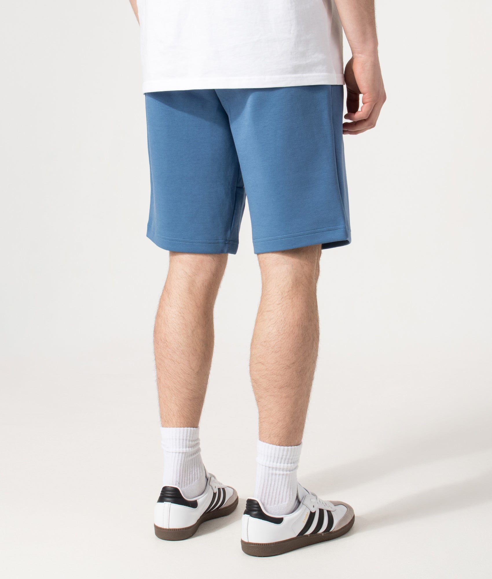 Polo Ralph Lauren Regular Fit Double Knit Athletic Sweat Shorts in Delta Blue at EQVVS Menswear. Angled model back shot.