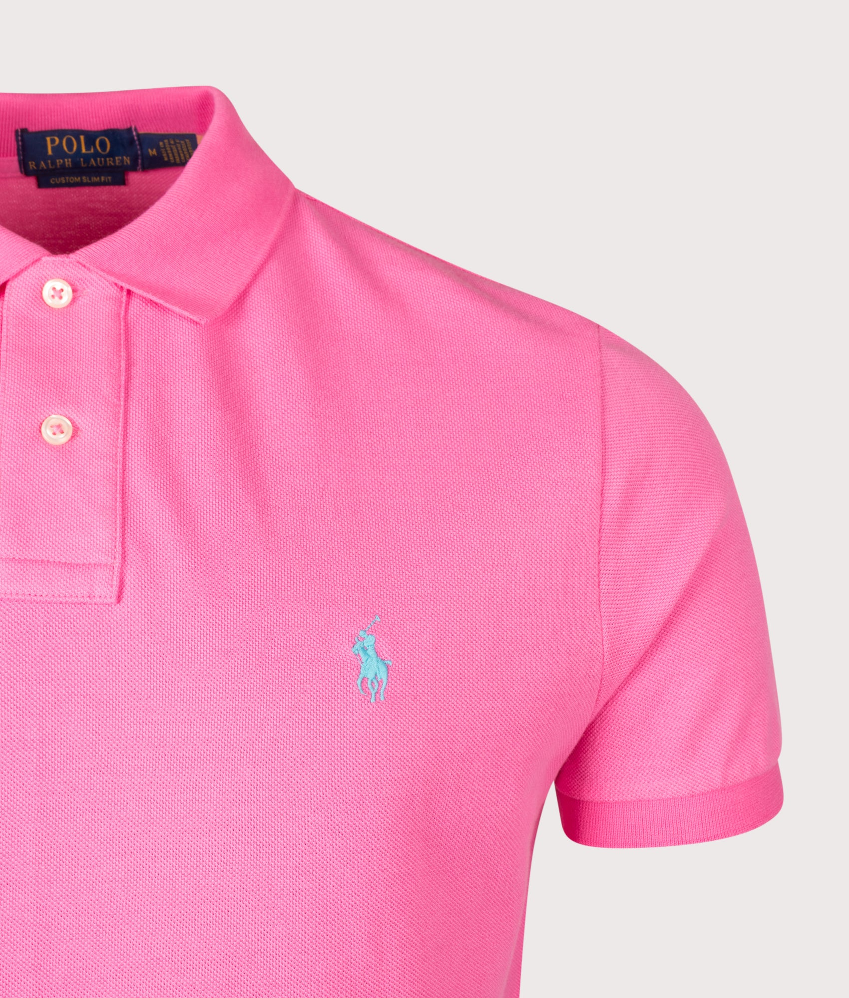 Custom Slim Fit Mesh Polo Shirt in Baja Pink by Polo Ralph Lauren. Shot by EQVVS. Detail shot.