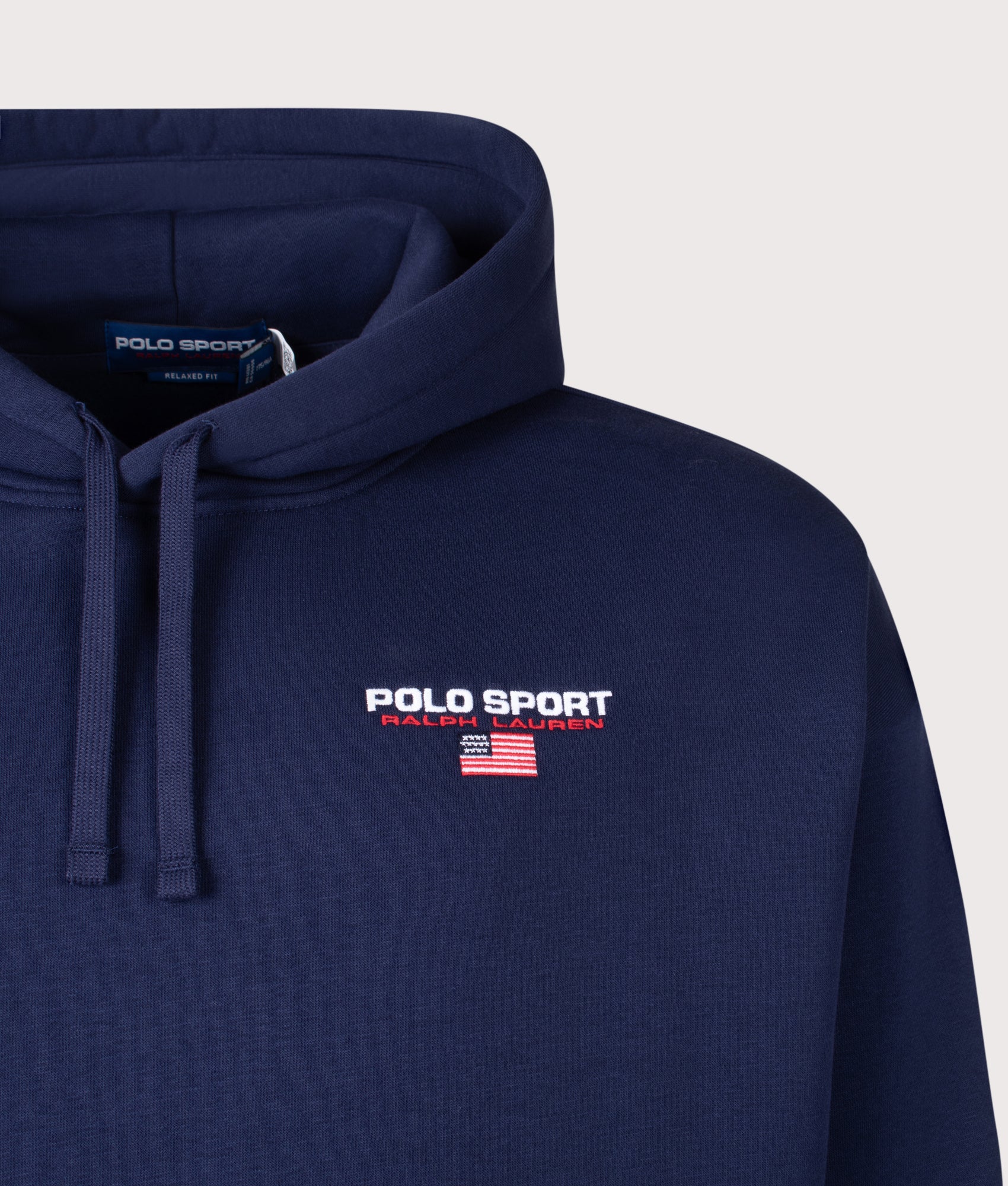 Polo Ralph Lauren Relaxed Fit Polo Sport Flag Logo Hoodie in Cruise Navy and White at EQVVS Menswear. Detail shot.