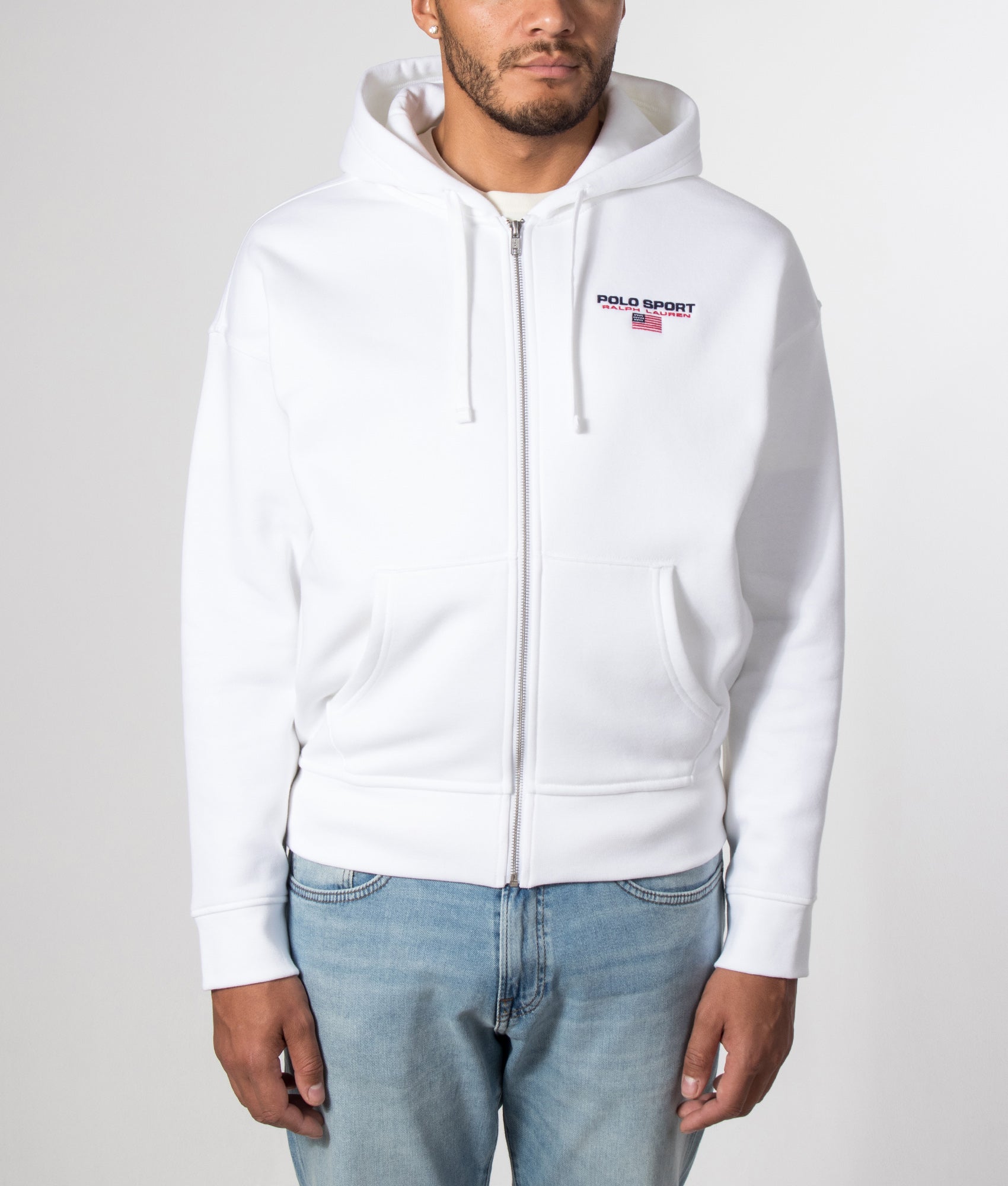 Polo Ralph Lauren Relaxed Fit Polo Sport Flag Logo Hoodie in White and Cruise Navy at EQVVS Menswear. Model front shot.