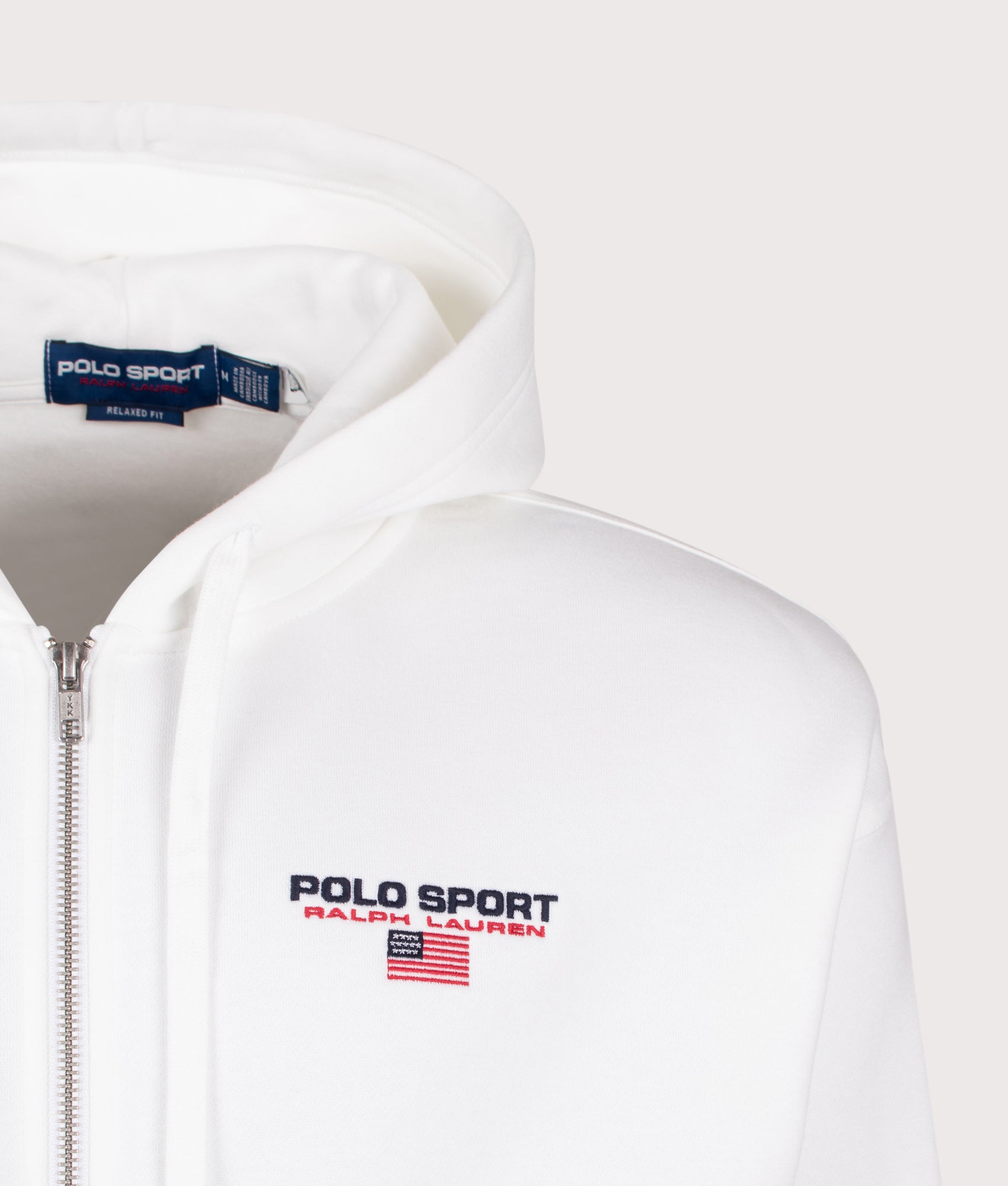 Polo Ralph Lauren Relaxed Fit Polo Sport Flag Logo Hoodie in White and Cruise Navy at EQVVS Menswear. Detail shot.