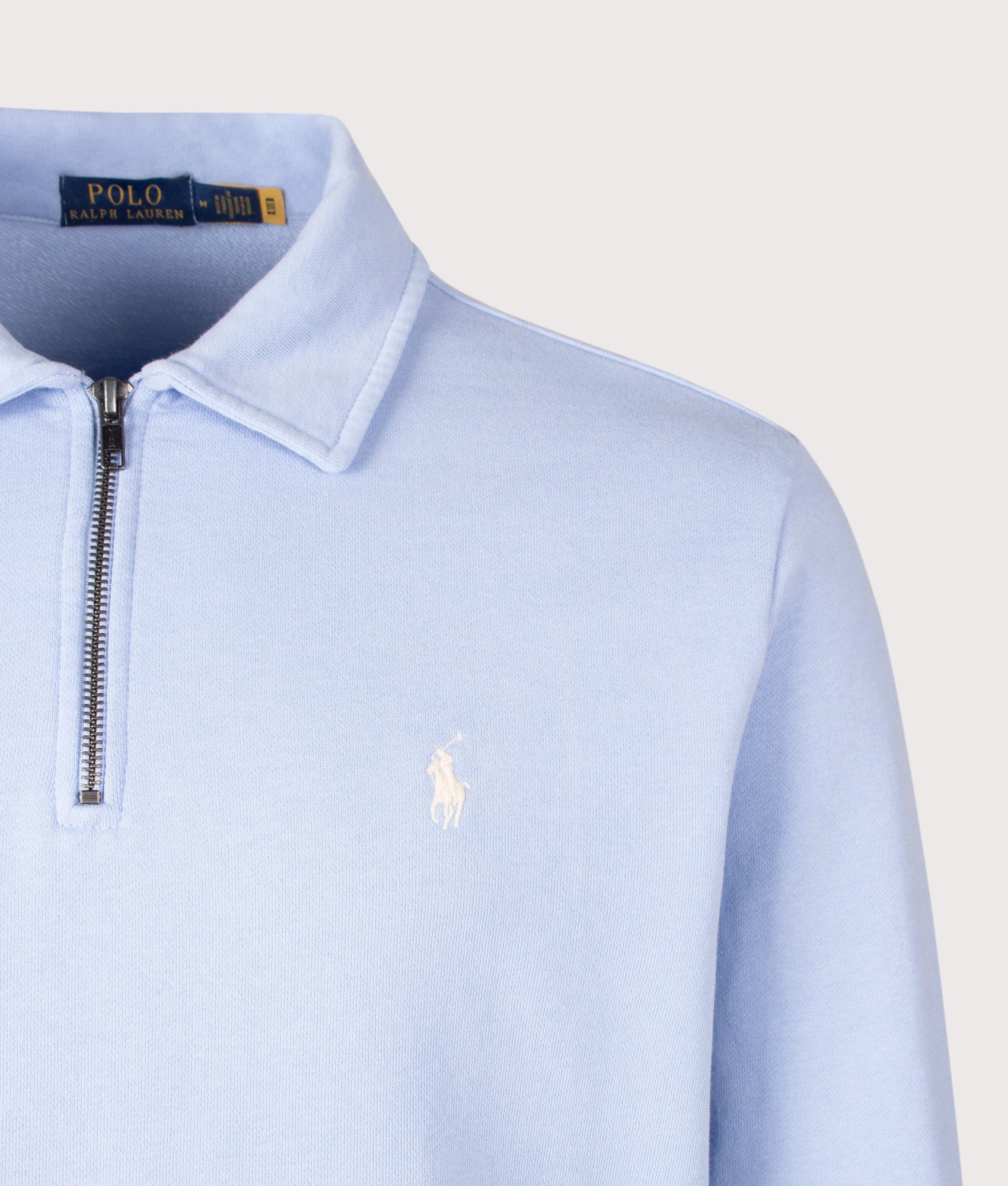 Polo Ralph Lauren Loopback Quarter Zip Sweatshirt in Pebble Blue at EQVVS Menswear. Detail shot.