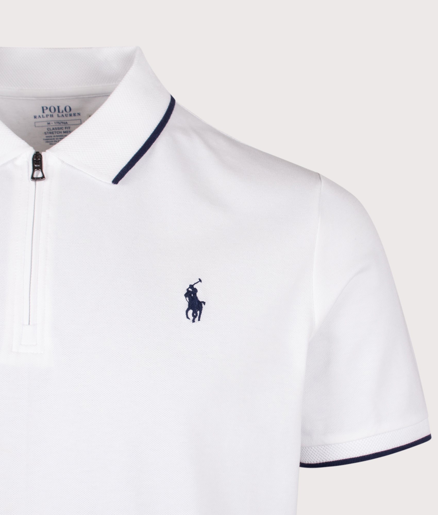 Polo Ralph Lauren Classic Fit Stretch Mesh Zip Polo Shirt in White at EQVVS Menswear. Detail shot.