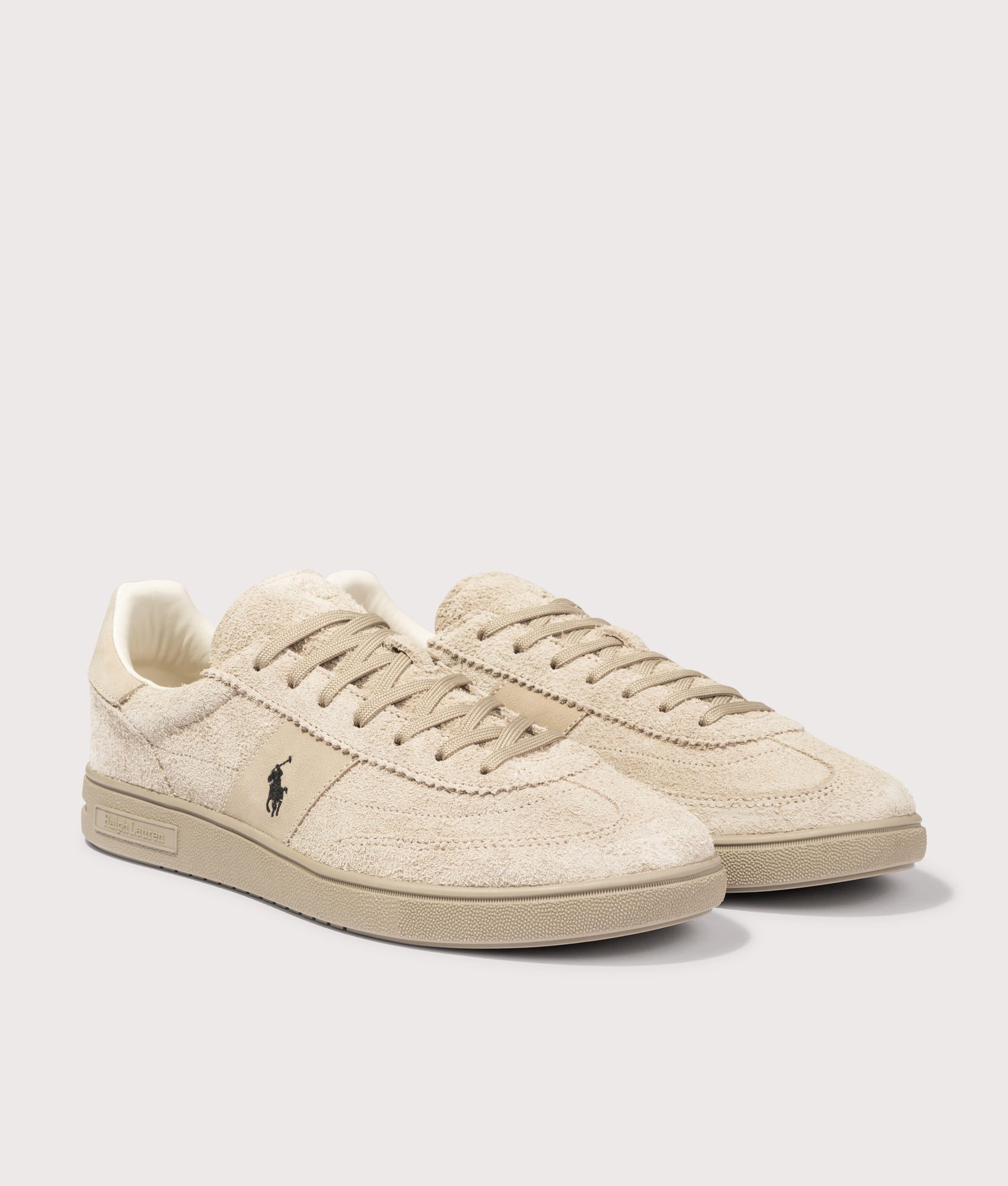 Polo Ralph Lauren Bedford Suede Sneakers in Tonal Milkshake at EQVVS Menswear. Angled front shot.