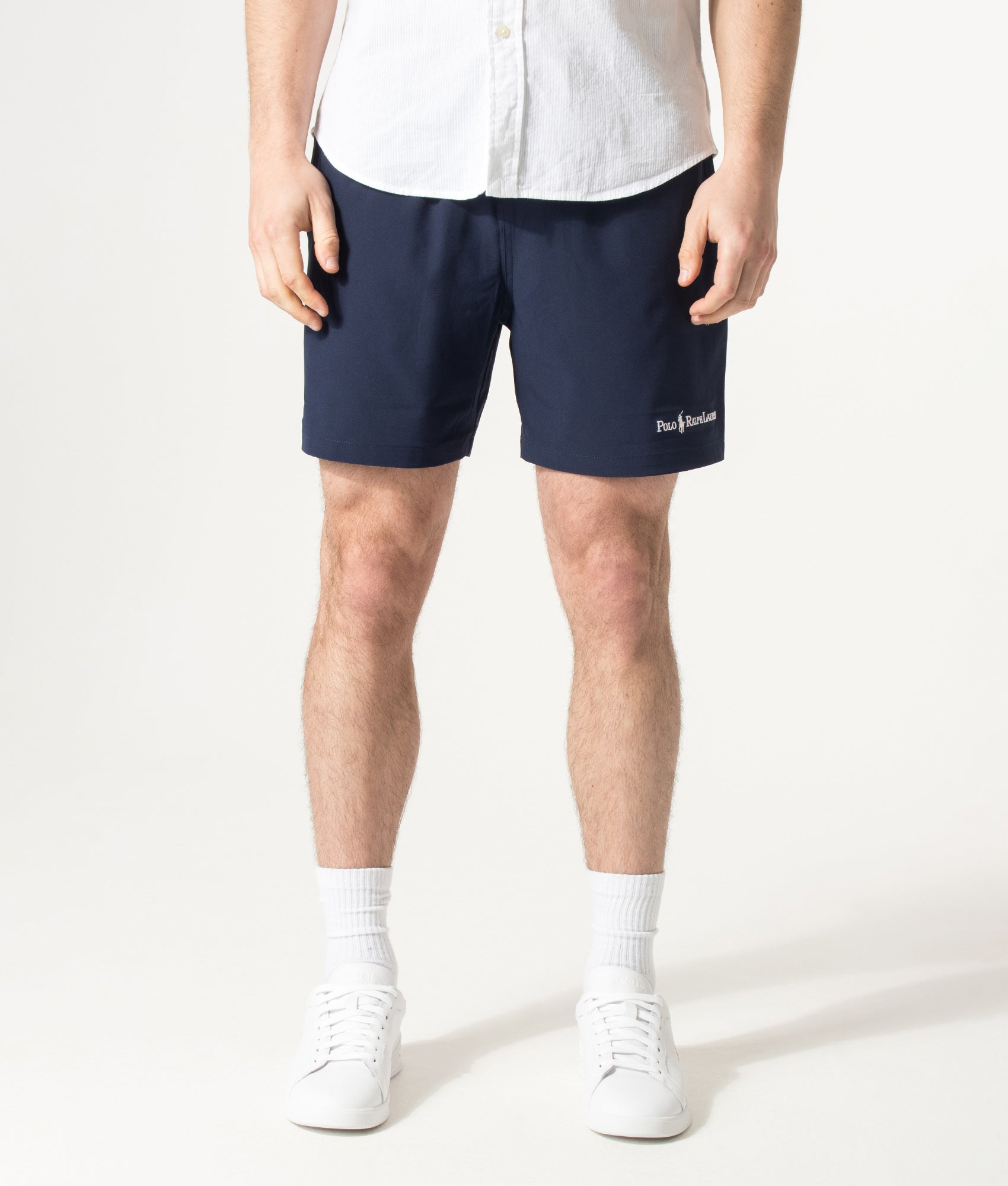 Polo Ralph Lauren 5.75 Inch Traveler Classic Swim Trunks in Cruise Navy and Emblem at EQVVS Menswear. Model front shot.