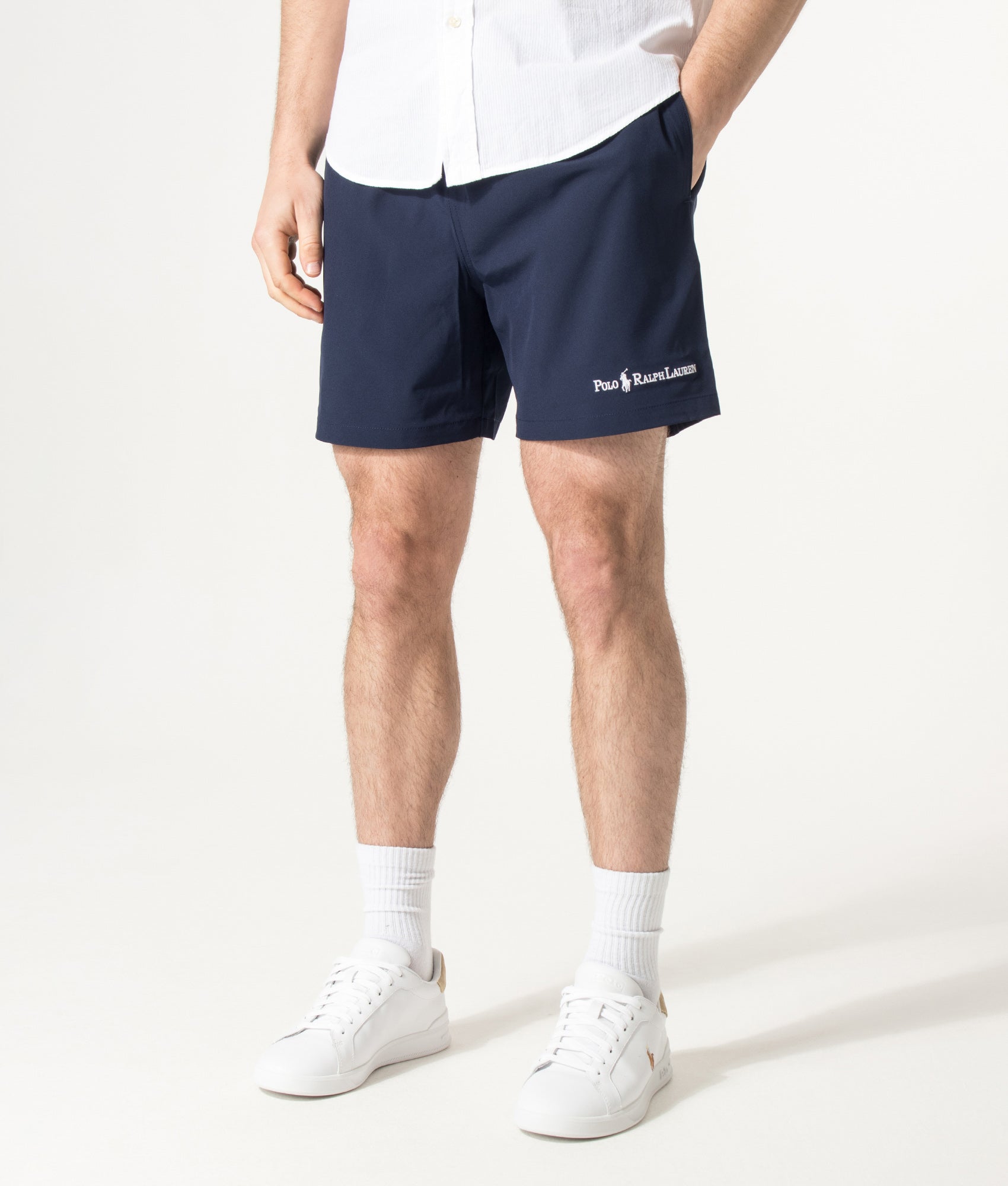 Polo Ralph Lauren 5.75 Inch Traveler Classic Swim Trunks in Cruise Navy and Emblem at EQVVS Menswear. Model front shot.