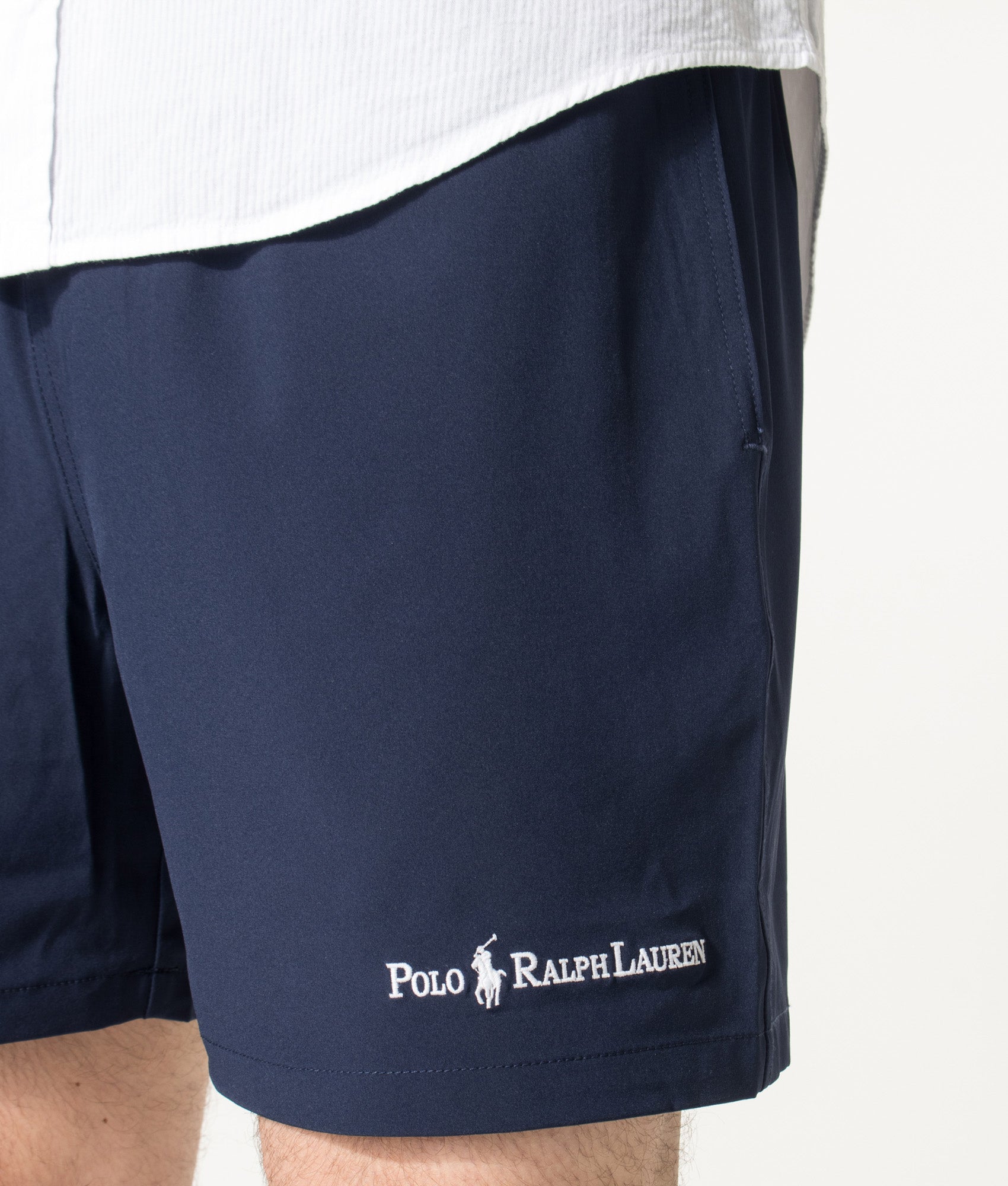 Polo Ralph Lauren 5.75 Inch Traveler Classic Swim Trunks in Cruise Navy and Emblem at EQVVS Menswear. Detail shot.