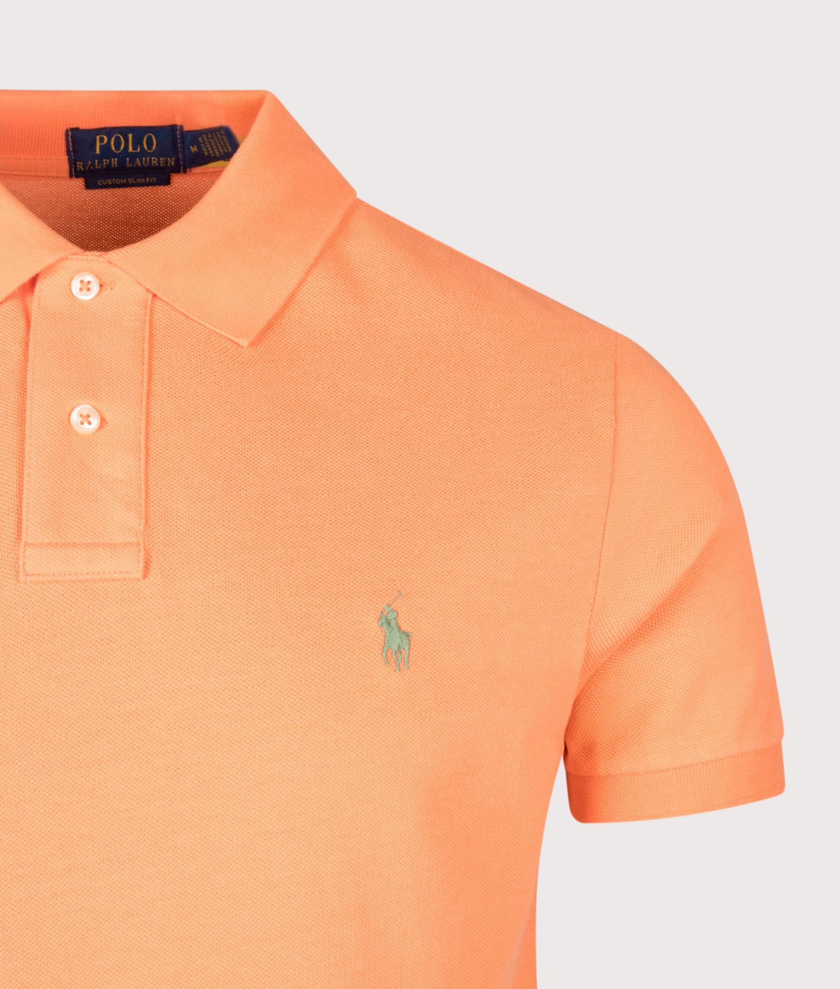 Custom Slim Fit Mesh Polo Shirt in Orange by Polo Ralph Lauren. Shot by EQVVS. Detail shot.