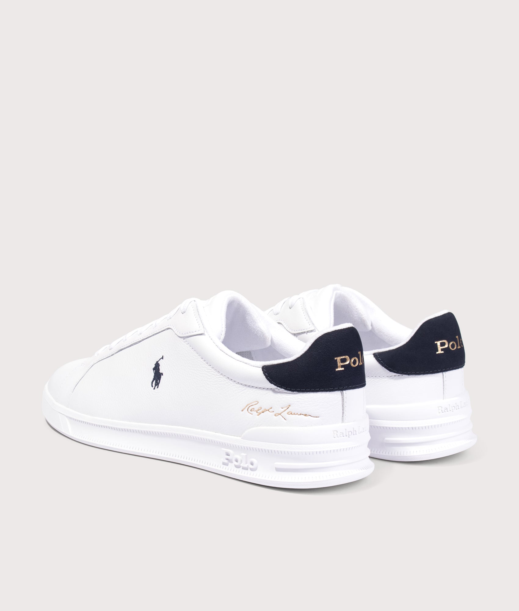 Polo Ralph Lauren Heritage Court II Leather Trainers in White and Hunter Navy at EQVVS Menswear. Angled back shot.