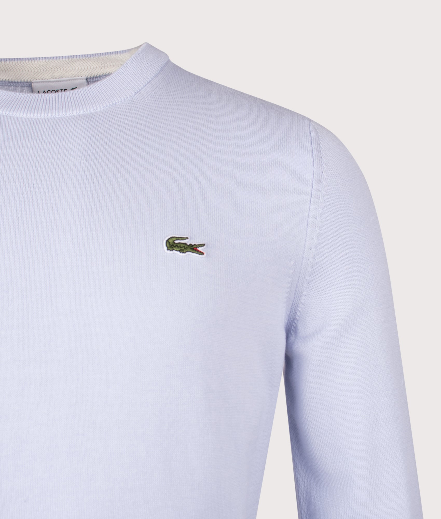 Lacoste Croc Logo Knitted Jumper in Phoenix Blue at EQVVS Menswear. Detail shot.