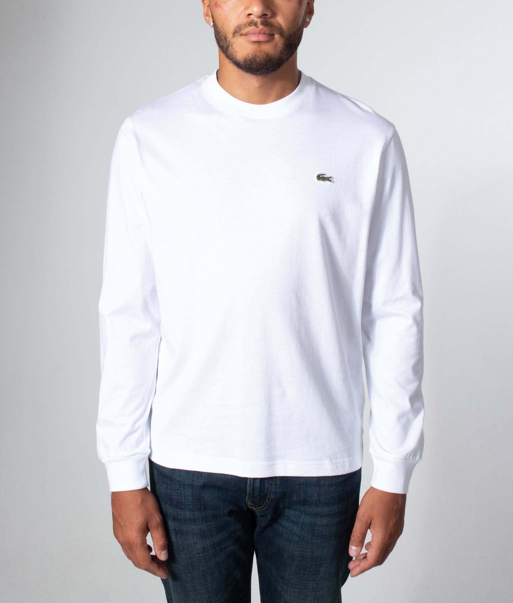Lacoste Classic Fit Long Sleeved Cotton T-Shirt in White at EQVVS Menswear. Model front shot.