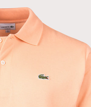 Lacoste Relaxed Fit L1212 Croc Logo Polo Shirt in IXY Light Orange Detail shot at EQVVS