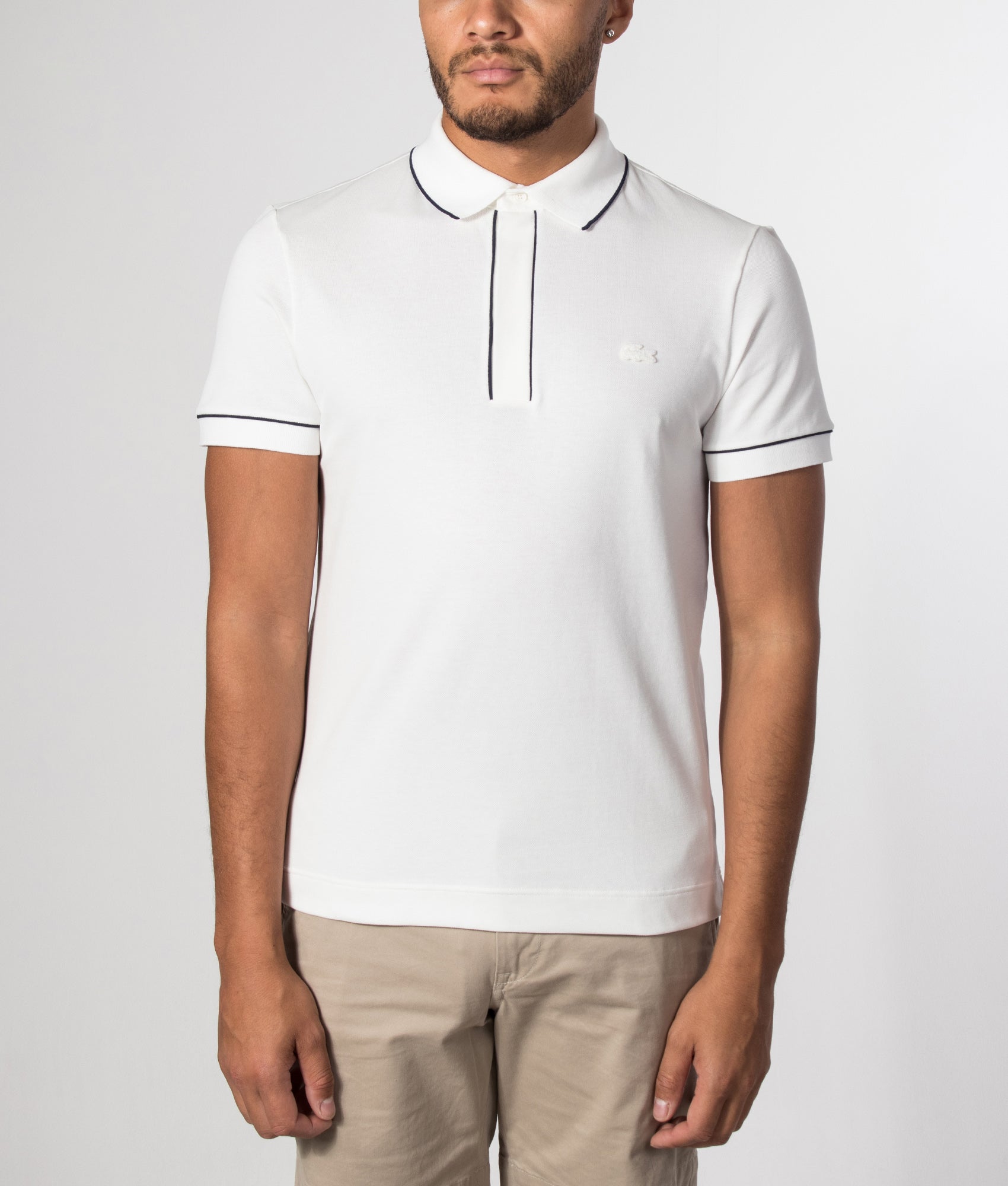 Lacoste Paris Stretch Piqué Polo Shirt in Flour at EQVVS Menswear. Model front shot.