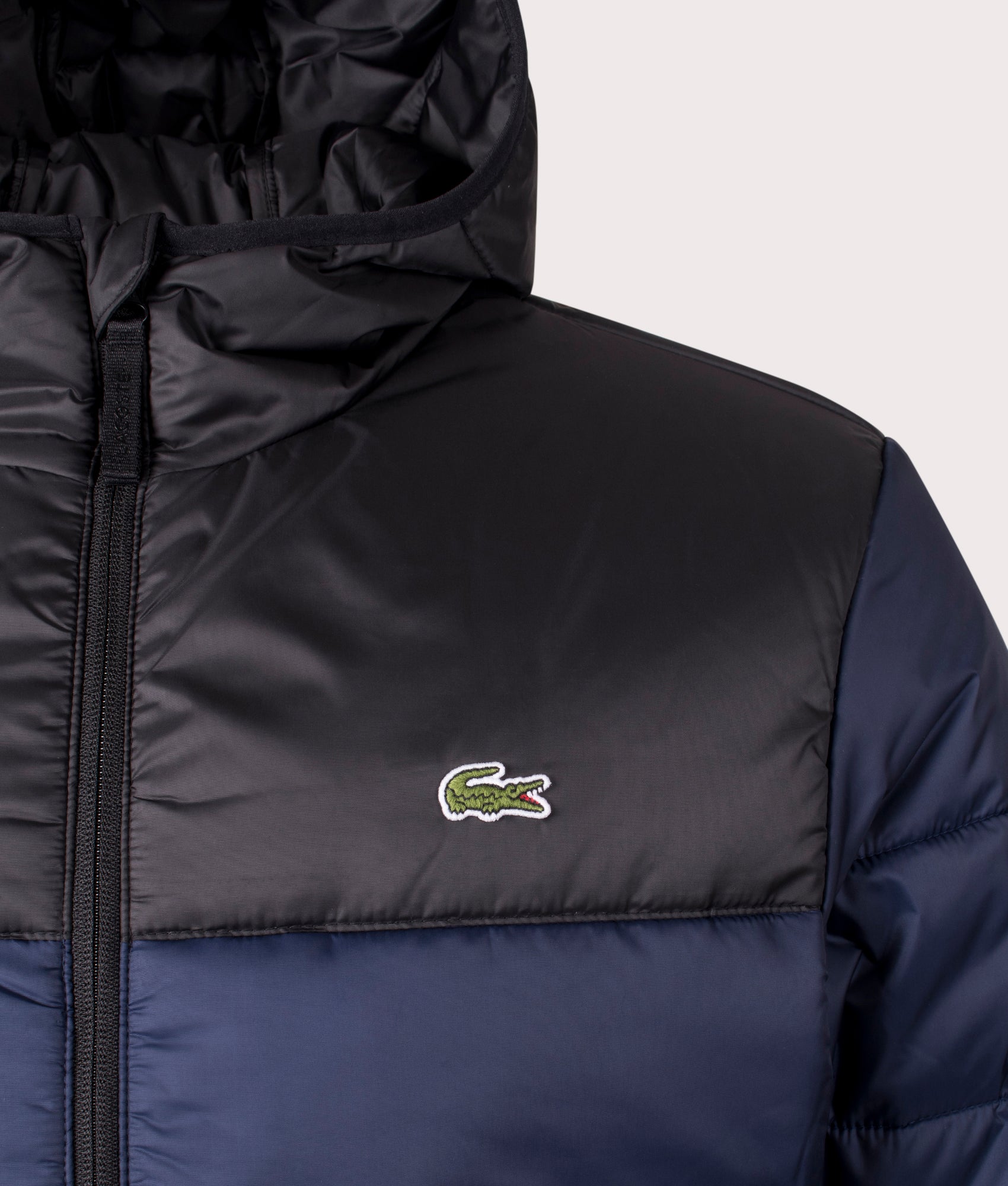 Lacoste Padded Hooded Jacket in Navy Blue and Black at EQVVS. Detail Shot