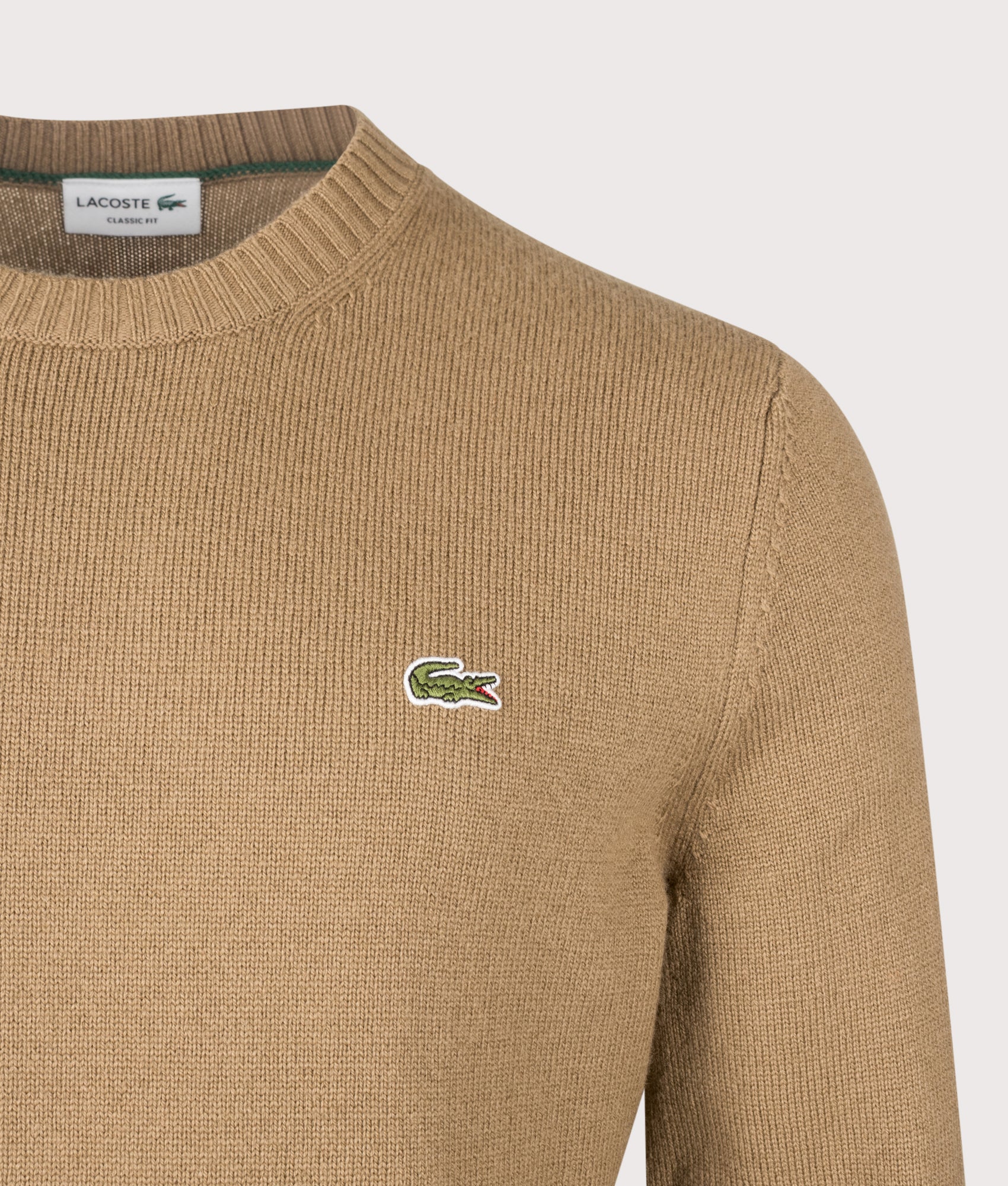 Lacoste Classic Fit Wool Crewneck Jumper in Cookie at EQVVS Menswear. Detail shot.
