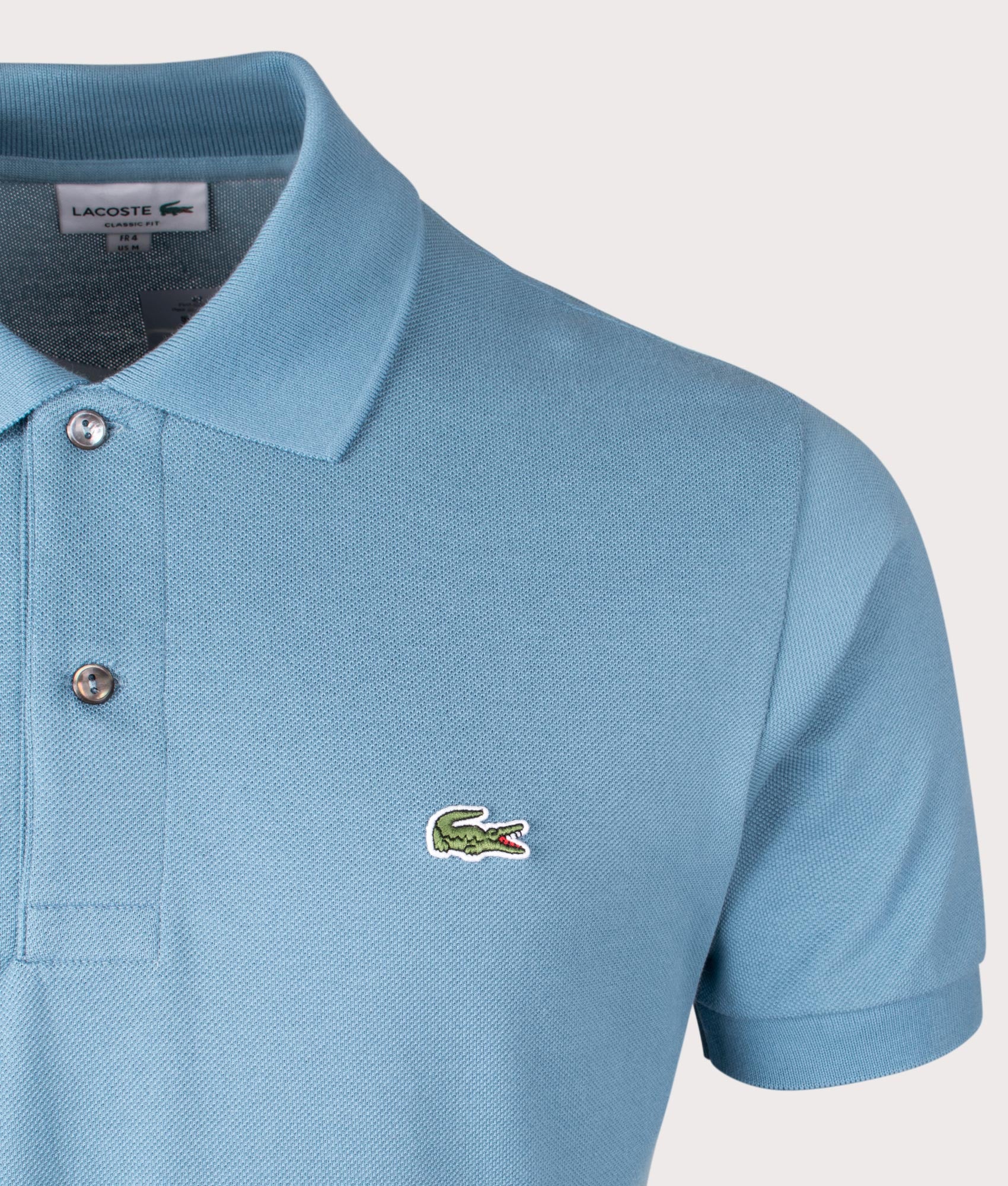 Lacoste L1212 Croc Logo Polo Shirt in Limestone Blue. EQVVS Detail Shot.