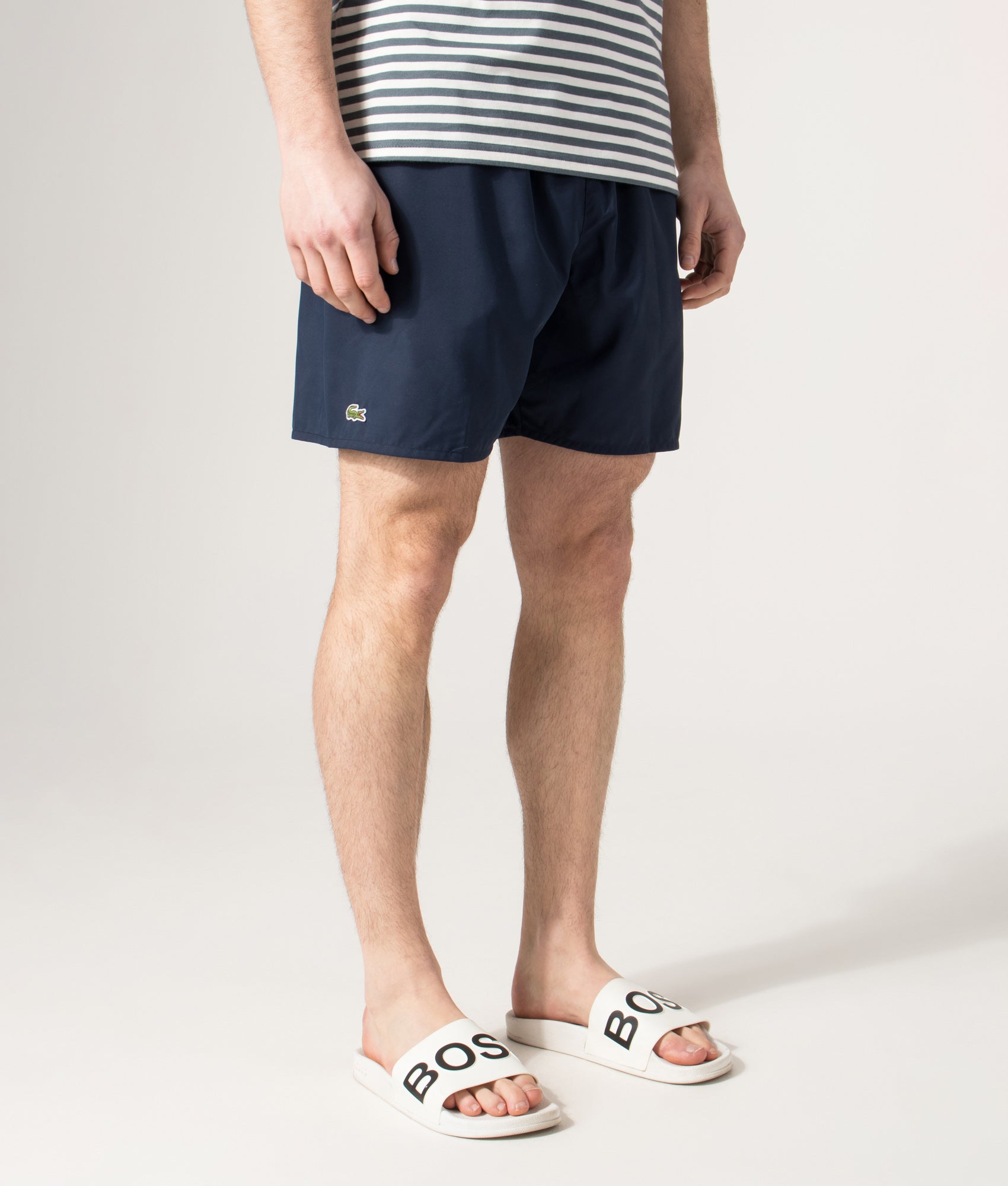 Lacoste Swim shorts in Navy and Green at EQVVS Menswear. Angled front shot. 