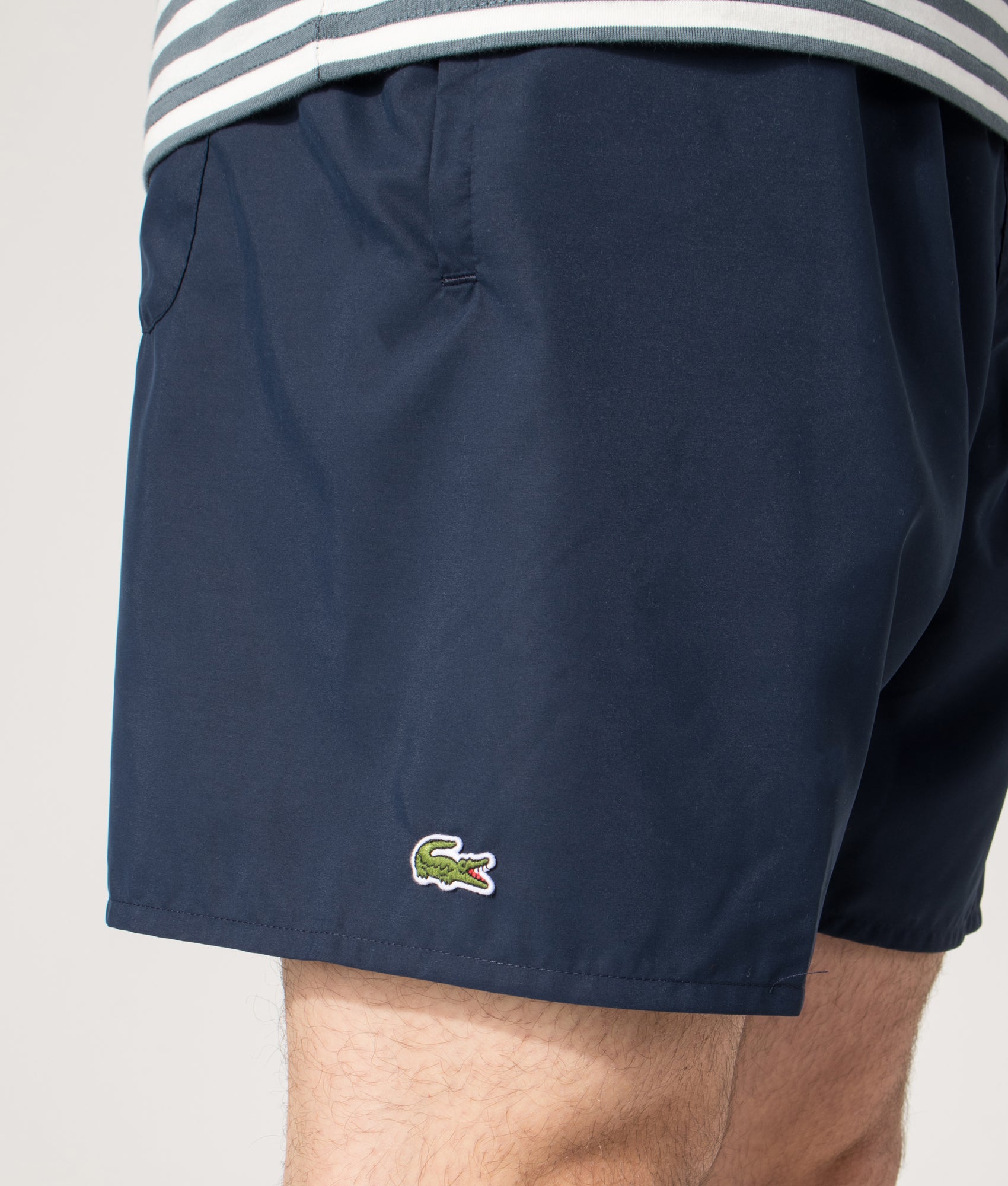 Lacoste Swim shorts in Navy and Green at EQVVS Menswear. Detail shot.
