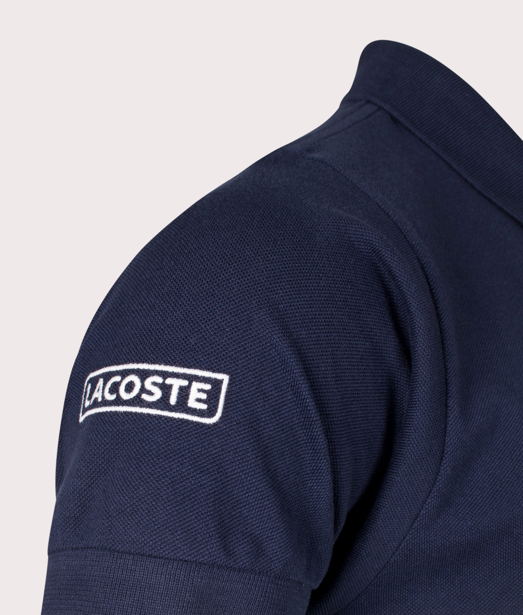 Lacoste French Made L1212 Polo Shirt in Navy at EQVVS. Sleeve Shot.