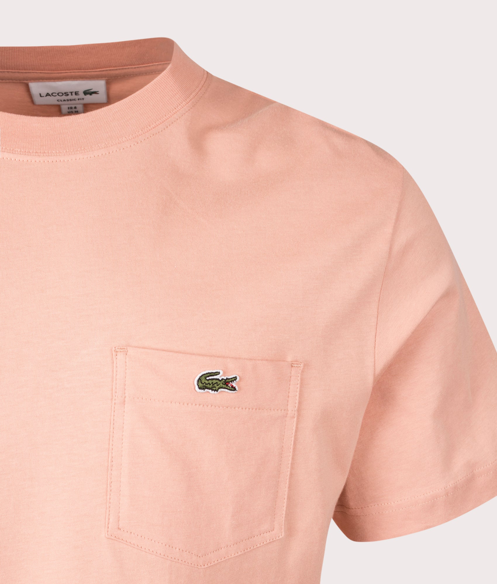 Lacoste Chest Pocket Cotton T-Shirt in Latte. Shot at EQVVS. Detail shot