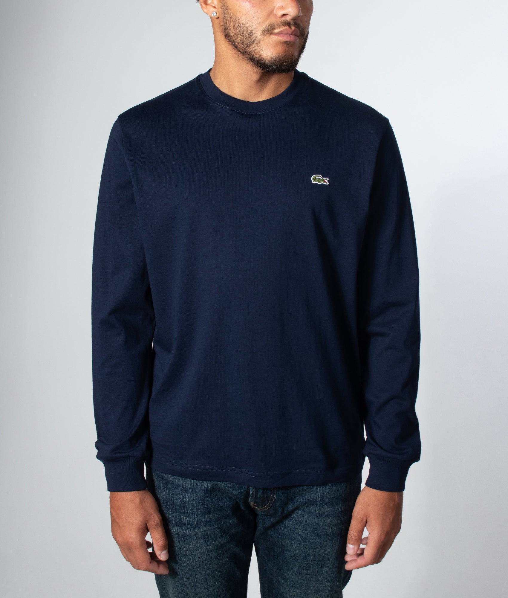 Lacoste Classic Fit Long Sleeved Cotton T-Shirt in Navy Blue at EQVVS Menswear. Model front shot.