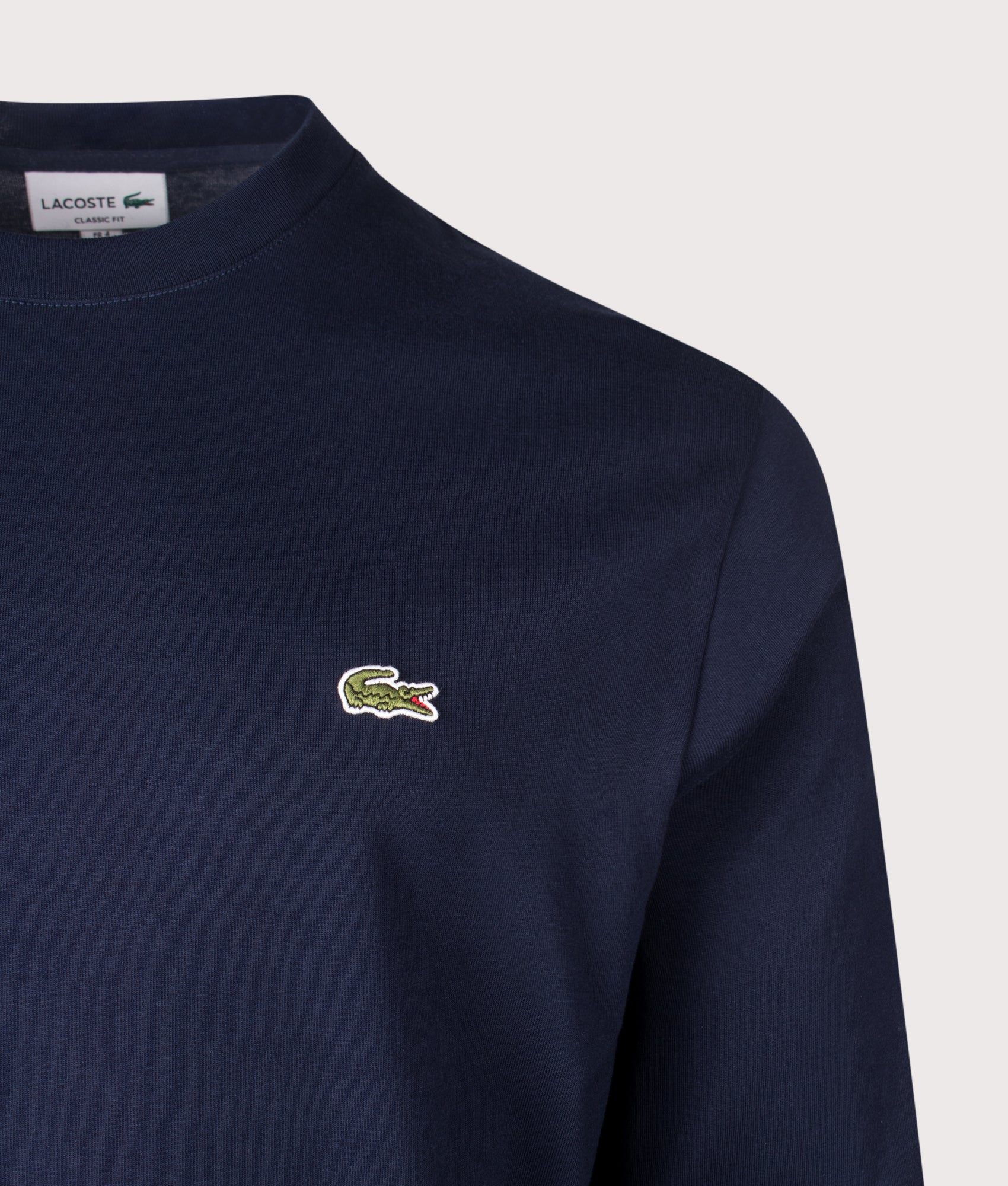 Lacoste Classic Fit Long Sleeved Cotton T-Shirt in Navy Blue at EQVVS Menswear. Detail shot.